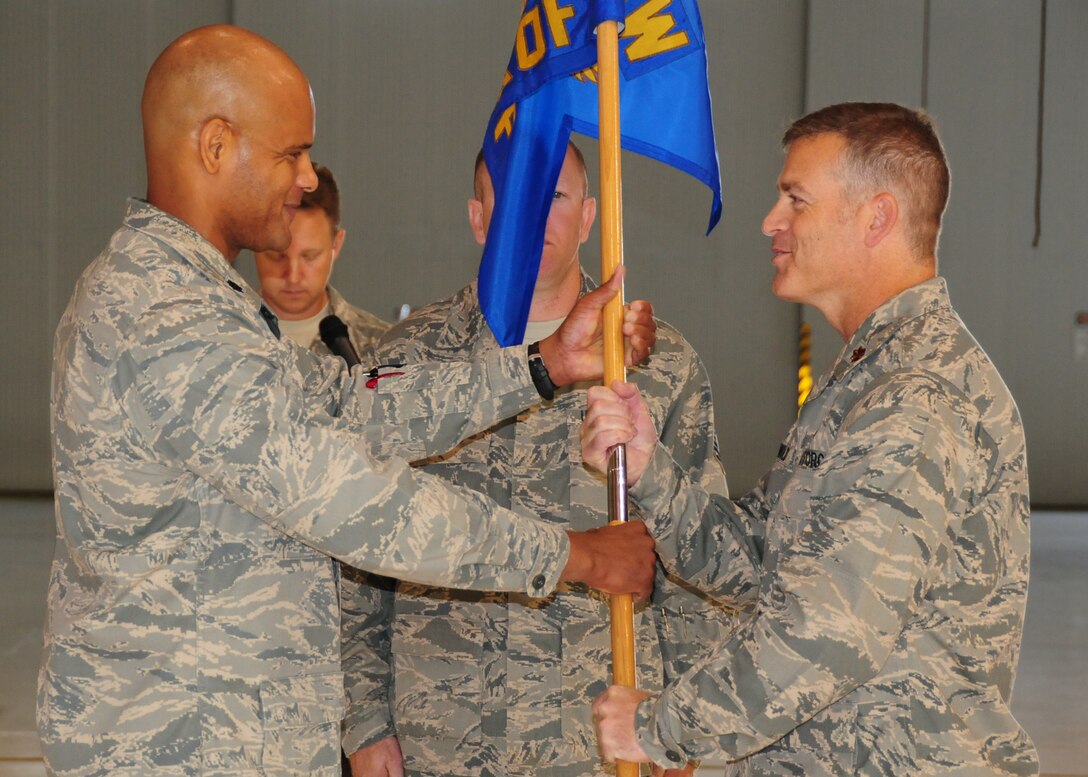 NIAGARA FALLS AIR RESERVE STATION, N.Y- Maj. Drew McDannold (right) receives the Flight Gideon from LtCol. Kelvin McElroy (left) 914th Maintenance Group Commander.  McDannold assumes command of the 914th Maintance Operations Flight effective as of September 11th (U.S. Air Force Reserve photo by Master Sgt. Peter Borys)