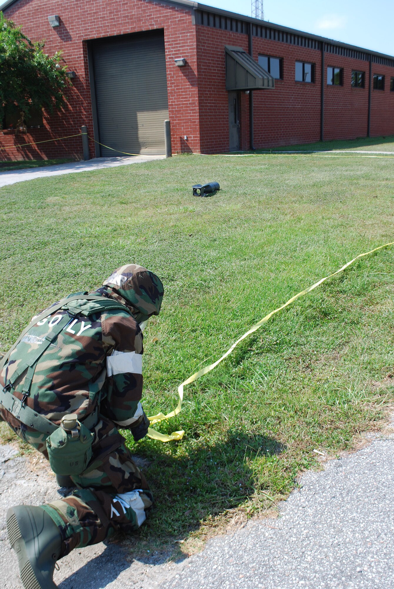A member of the 315th Airlift Wing marks a cordon around a simulated unexploded ordnance during an operational readiness exercise here Sept. 11, 2010. Charleston's operational readiness inspection is scheduled to take place Nov. 29 - Dec. 6, 2011, which signals the beginning of the ORI prep season for Airmen in the 315th Airlift Wing. As part of the preparation emergency managers from throughout 22nd Air Force are here to proactively train Reservists. During this weekend’s unit training assembly multiple exercises were conducted to assess the wing’s ability to survive & operate. (U.S. Air Force photo/Capt. Bryan Lewis)
