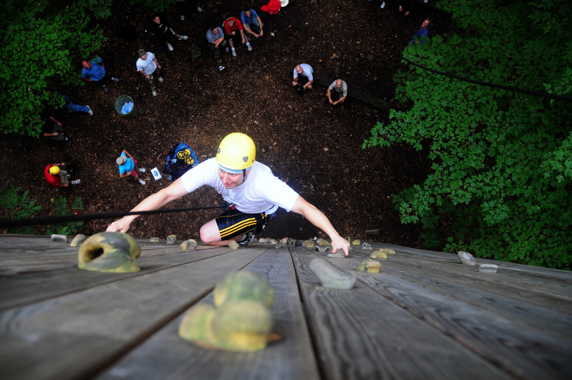 WALL CLIMB  U.S. Air Force Tech. Sgt. Travis Kowalski navigates the wall climb at the Pretty Lake Adventure Center, Kalamazoo, Mich. Aug. 21, 2010 while 110th Airlift Wing Service members watch from below. The 110th Airlift Wing servicemembers were participating in the Adventure Centers’ Leadership training course. (U.S. Air Force photo by Tech. Sgt. Sonia Calbaugh/Released)