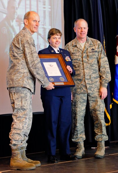 Retired Master Sgt. Nancy Young and Maj. Gen. William Reddel III, the Adjutant General of the N.H. National Guard, hold a rosewood encased, framed, personalized letter of appreciation from General McKinley as part of the 157th Air Refueling Wing's first Hometown Heroes celebration. Also pictured is Chief Master Sgt. Christopher Muncy, Command Chief Master Sgt. of the Air National Guard