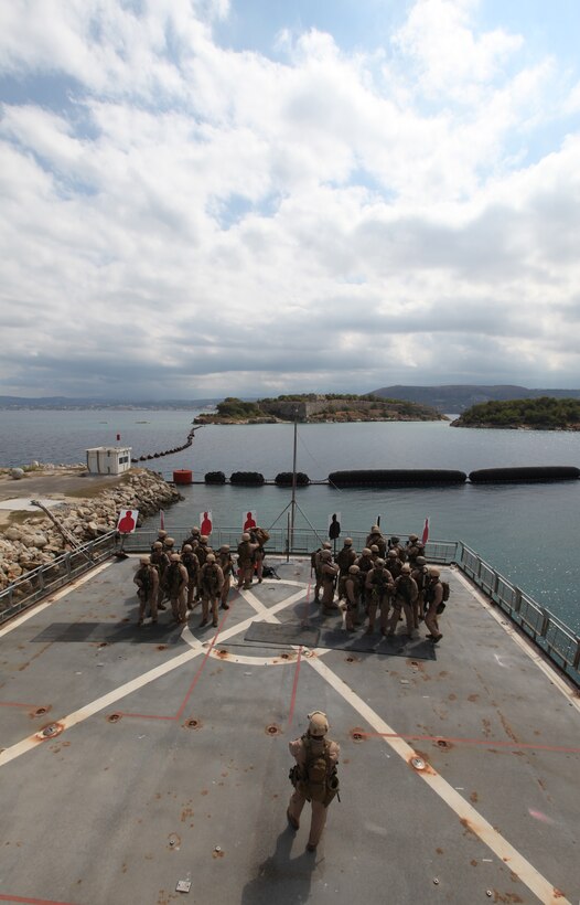 Marines and sailors with Reconnaissance Platoon, Battalion Landing Team 3/8, 26th Marine Expeditionary Unit,  assemble on the deck aboard HNS Aris during a simulated Maritime Interdiction Operation at Souda Bay, Crete, Greece, Sept. 13, 2010. 26th MEU deployed aboard the ships of Kearsarge Amphibious Ready Group in late August responding to an order by the Secretary of Defense to support Pakistan flood relief efforts.