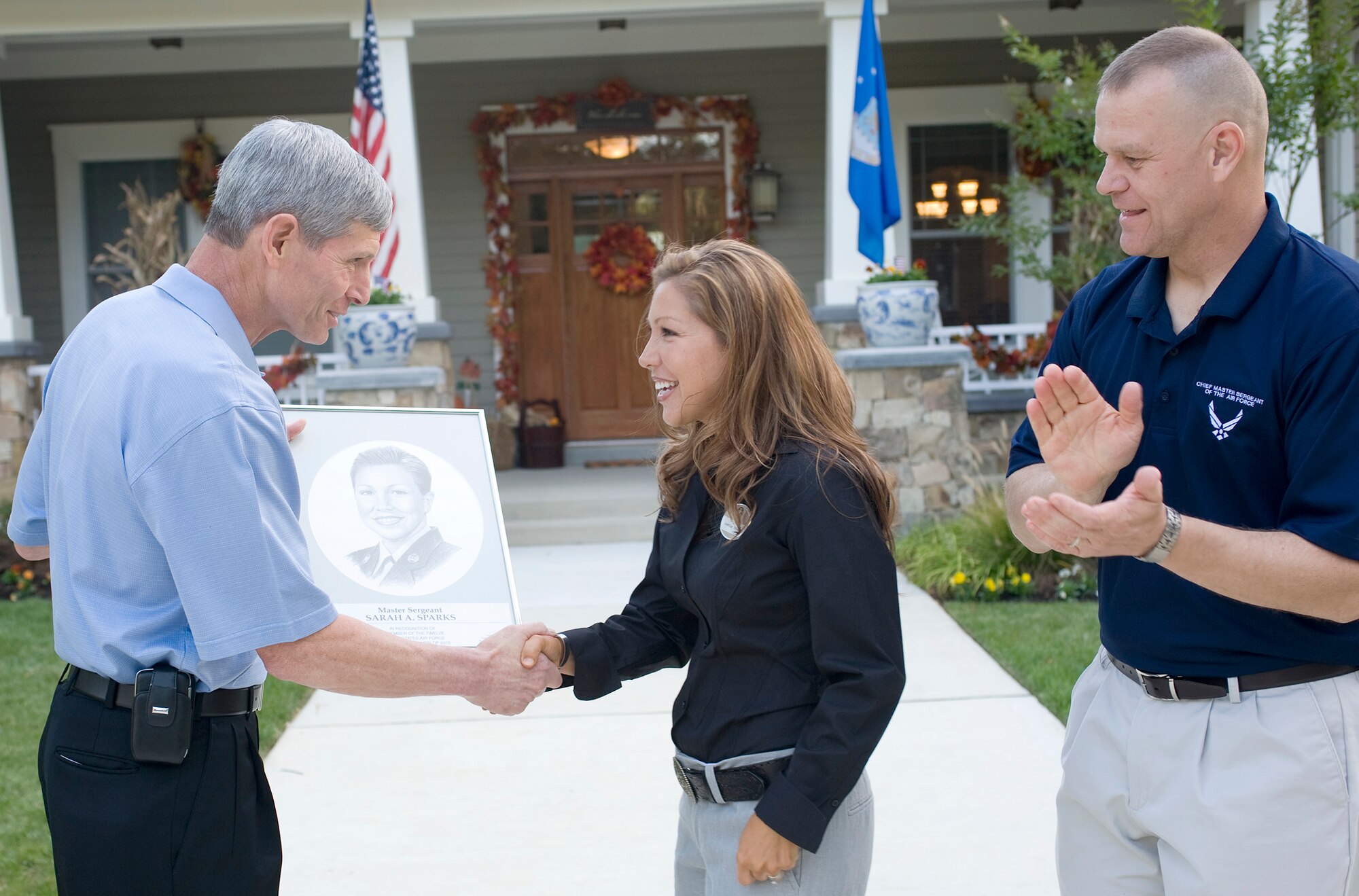 Air Force Chief of Staff Gen. Norton Schwartz (left) and Chief Master Sgt. of the Air Force James Roy congratulate Senior Master Sgt. Sarah Sparks, one of the 12 Outstanding Airmen of the Year, Sept. 11, 2010, at Airey House on Andrews Air Force Base, Md. Chief Roy hosted a social in honor of the Airmen. This awards program began in 1956. Each year the program recognizes 12 enlisted Airmen for their superior leadership, job performance, community involvement and personal achievements. (U.S. Air Force photo/Jim Varhegyi)