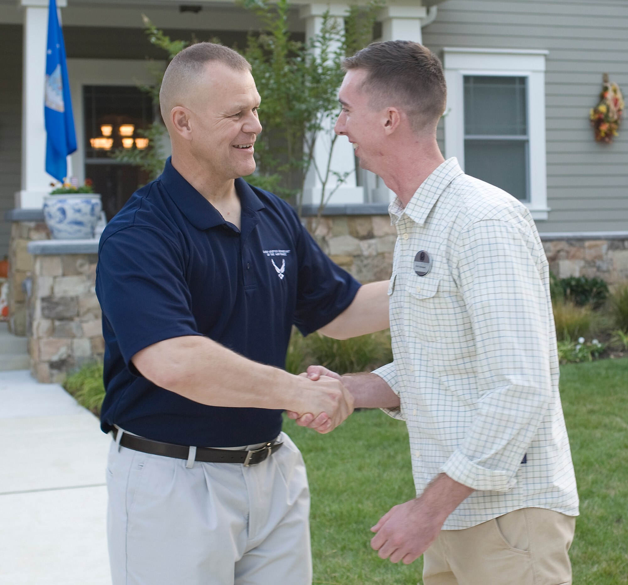 Chief Master Sgt. of the Air Force James Roy (left) congratulates Senior Airman Samuel Siewert, one of the 12 Outstanding Airmen of the Year, Sept. 11, 2010, at Airey House on Andrews Air Force Base, Md. Chief Roy hosted a social in honor of the Airmen. This awards program began in 1956. Each year the program recognizes 12 enlisted Airmen for their superior leadership, job performance, community involvement and personal achievements. (U.S. Air Force photo/Jim Varhegyi)