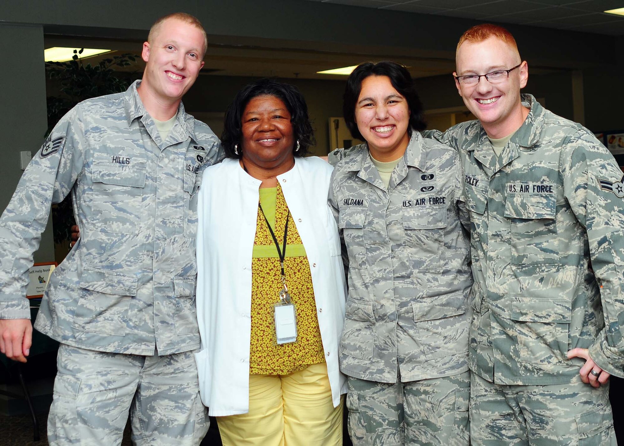 ALTUS AIR FORCE BASE, Okla. -- Satff Sgt. Adam Hills, Airmen 1st Class Arryawana Saldana and Bryan Foley, 97th Civil Engineer Squadron, reunited with Rosa Jenkins, 97th Medial Group, Sept. 13. Jenkins and her grandson were involved in an accident on Highway 62 Sept. 8. The Airmen directed traffic and helped her and her grandson to safety. (U.S. Air Force photo by Senior Airman Leandra D. Hernandez/Released 97th Air Mobility Wing Public Affairs)