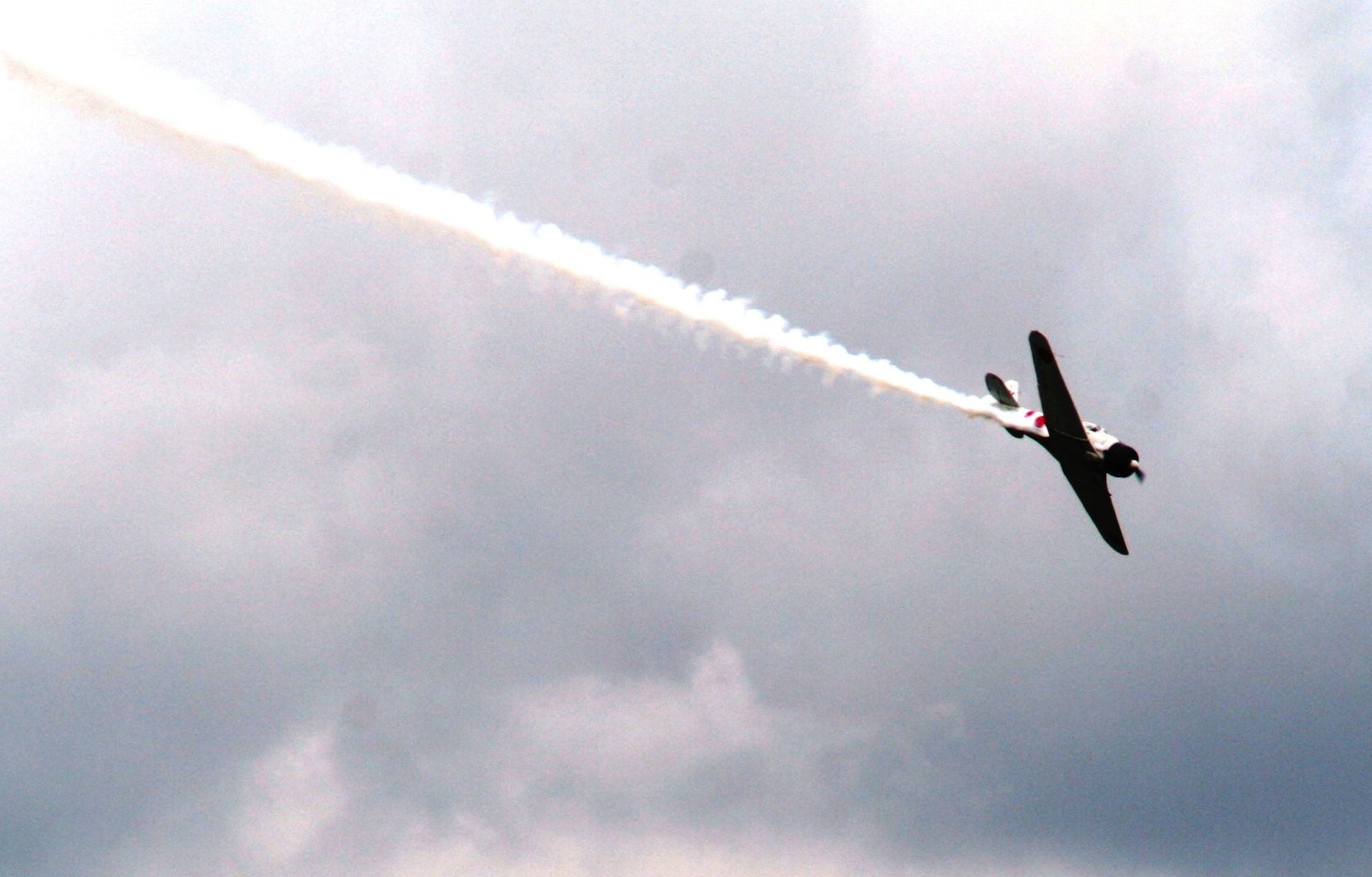 Vintage World War II-era aircraft flies through the air during the "Tora! Tora! Tora!" aerial demonstration by the Commemorative Air Force for the 2010 Airpower Over The Midwest Airshow on Sept. 11, 2010, at Scott Air Force Base, Ill. The demonstration re-enacts the Pearl Harbor attack. Tens of thousands of people attended the two-day airshow. (U.S. Air Force Photo/Master Sgt. Scott T. Sturkol)