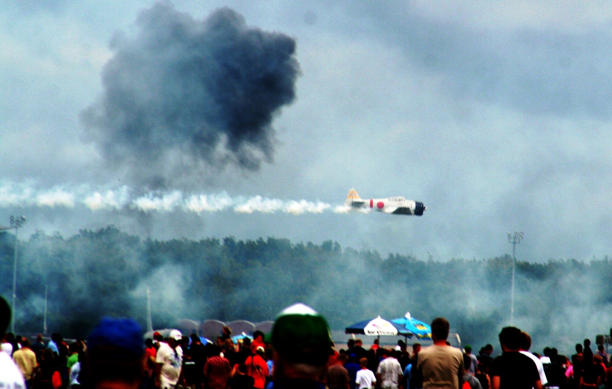 Vintage World War II-era aircraft flies through the air during the "Tora! Tora! Tora!" aerial demonstration by the Commemorative Air Force for the 2010 Airpower Over The Midwest Airshow on Sept. 11, 2010, at Scott Air Force Base, Ill. The demonstration re-enacts the Pearl Harbor attack. Tens of thousands of people attended the two-day airshow. (U.S. Air Force Photo/Master Sgt. Scott T. Sturkol)