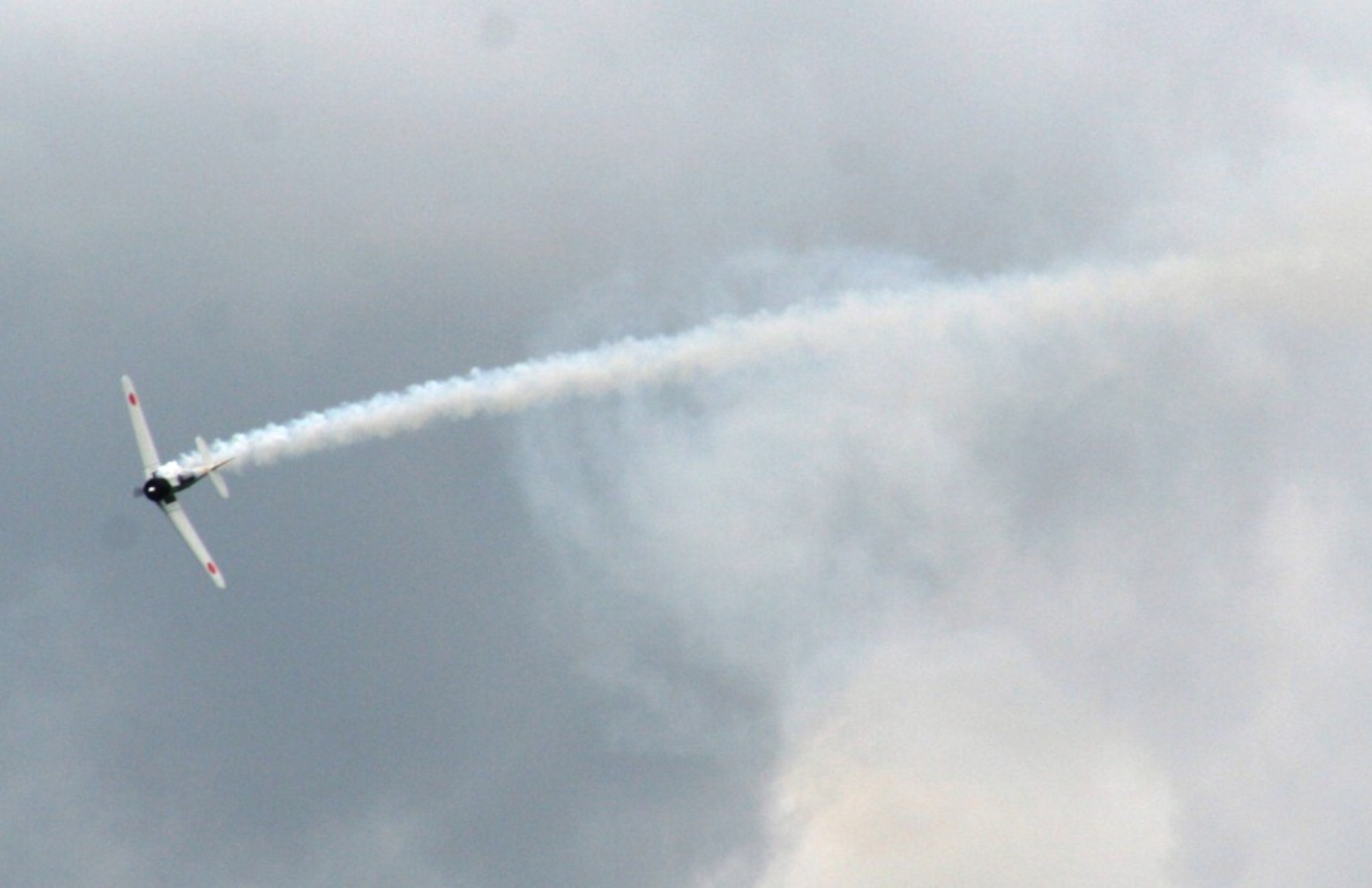 Vintage World War II-era aircraft flies through the air during the "Tora! Tora! Tora!" aerial demonstration by the Commemorative Air Force for the 2010 Airpower Over The Midwest Airshow on Sept. 11, 2010, at Scott Air Force Base, Ill. The demonstration re-enacts the Pearl Harbor attack. Tens of thousands of people attended the two-day airshow. (U.S. Air Force Photo/Master Sgt. Scott T. Sturkol)