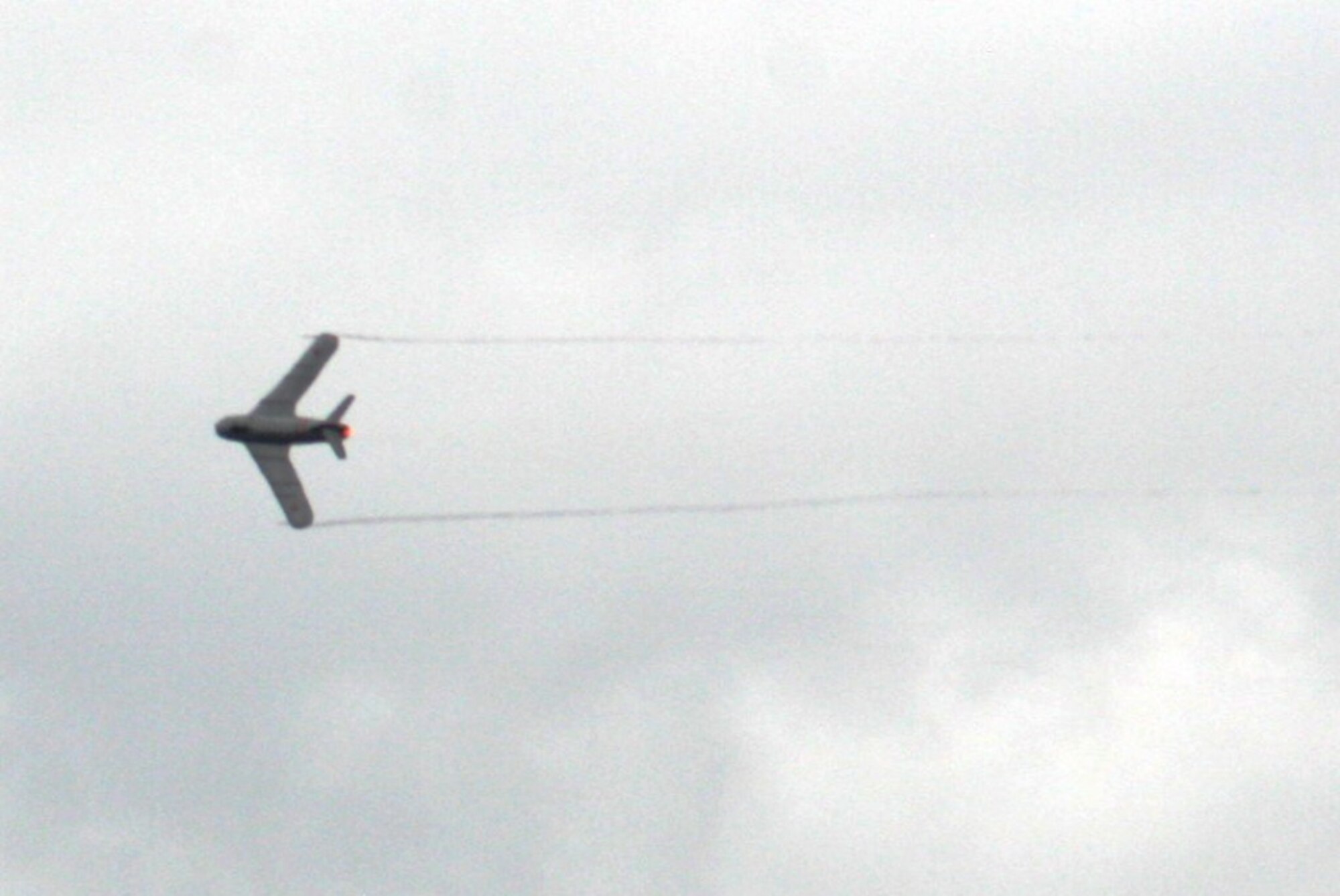 A pilots guides a vintage Russian-built MiG 17 jet during an aerial demonstration for the 2010 Airpower Over The Midwest Airshow on Sept. 11, 2010, at Scott Air Force Base, Ill. Tens of thousands of people attended the two-day airshow. (U.S. Air Force Photo/Master Sgt. Scott T. Sturkol)