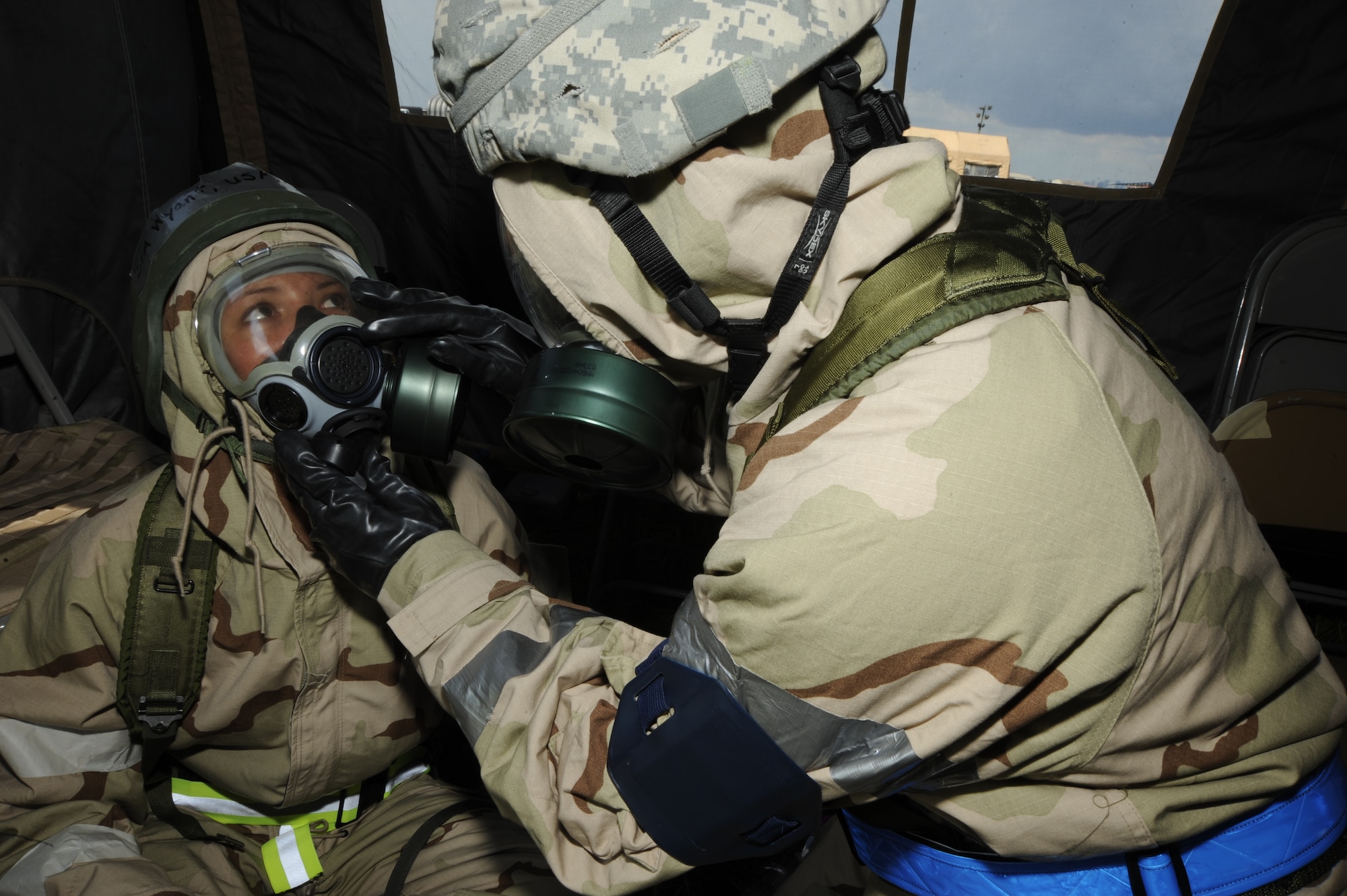 Senior Airman Anna Wyant, 927th Air Refueling Squadron, and Senior Master Sgt. Terry Montrose, 6th Air Mobility Wing, use the buddy system after donning MOPP four gear during a training exercise at Camp Thunder, MacDill Air Force Base, Fla., Sept. 12, 2010. More than 300 Airmen from the 6th AMW and the 927th ARW participated in the training in preparation for the upcoming Operational Readiness Exercise. (U.S. Air Force photo by Staff Sgt. Angela Ruiz)