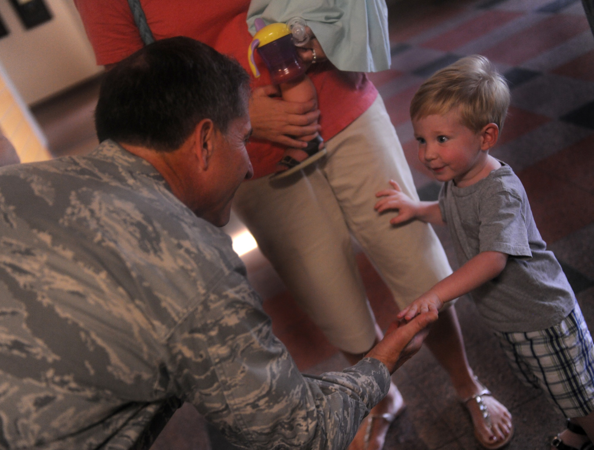 MOODY AIR FORCE BASE, Ga. -- Maj. Gen. David Goldfein, Air Combat Command director of air and space operations, gives a high five to Noah Kunkel, son of Lt. Col. Tom Kunkel, 41st Rescue Squadron commander, during a base visit here Sept. 1. General Goldfein was rescued by Colonel Kunkel when his aircraft was shot down in May 1999. (U.S. Air Force photo/Airman 1st Class Benjamin Wiseman)
