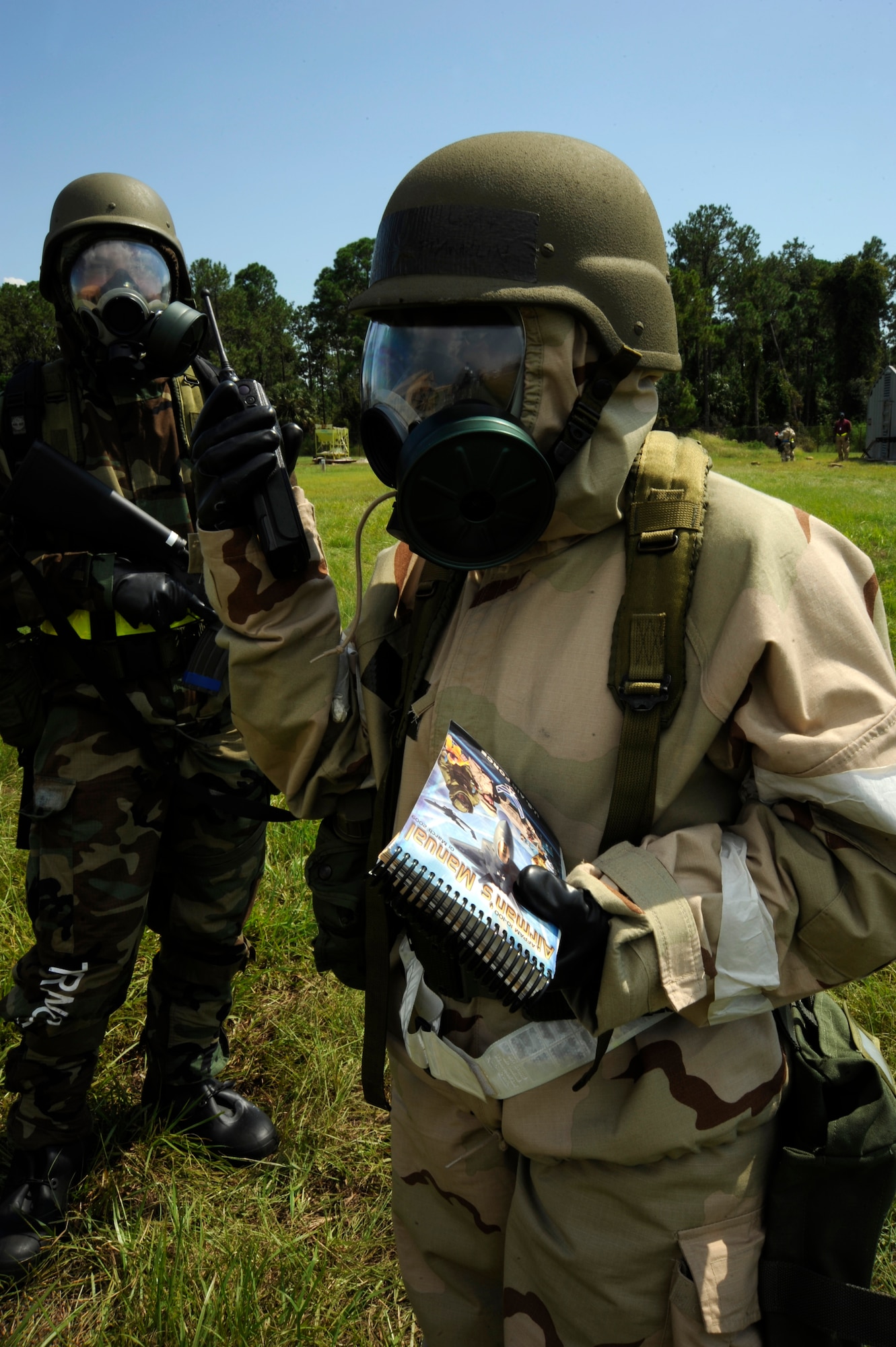 Airmen in MOPP four radio in their findings for a Post Attach Reconnaissance sweep into the Unit Control Center during a training exercise at Camp Thunder, MacDill Air Force Base, Fla., Sept. 12, 2010. More than 300 Airmen from the 6th Air Mobility Wing and the 927th Air Refueling Wing participated in the training in preparation for the upcoming Operational Readiness Exercise. (U.S. Air Force photo by Staff Sgt. Angela Ruiz)