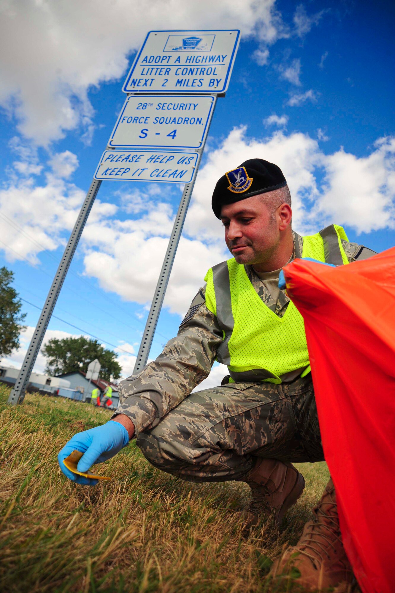ELLSWORTH AIR FORCE BASE S.D. – Master Sgt. Eric Soluri, 28th Security Forces Squadron logistics flight superintendent, picks up trash, Sept. 2. Sergeant Soluri has volunteered with his flight in Adopt-A-Highway  to maintain cleanliness of their designated area of 2 miles. (U.S. Air Force photo/Senior Airman Corey Hook)