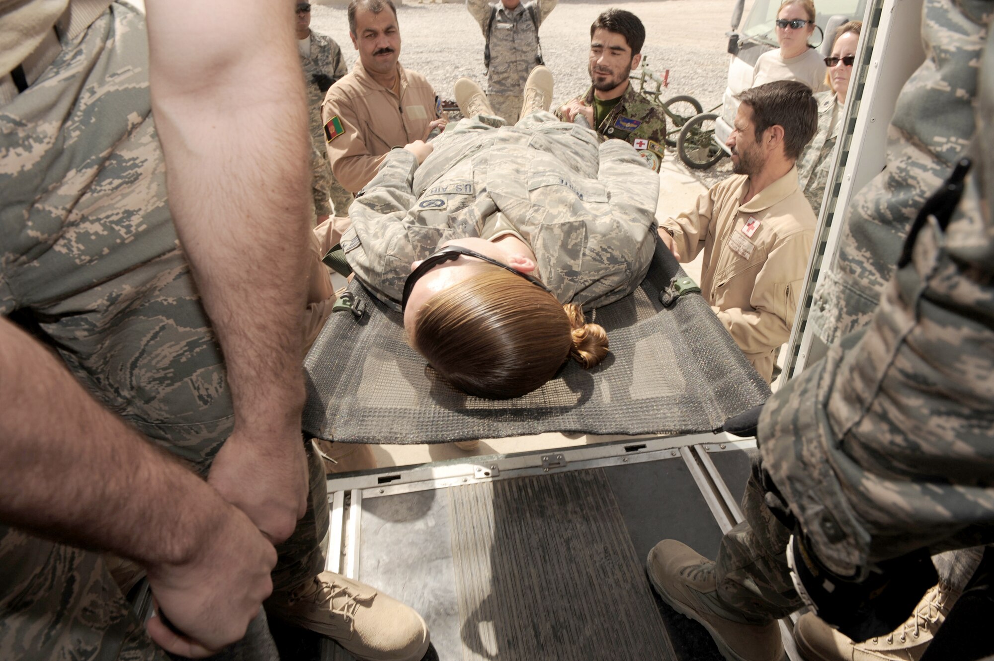 Afghan Air Force flight medics transfer a simulated patient to an ambulance during an orientation offered by 451st Expeditionary Aeromedical Evacuation Squadron members Sept. 8, 2010, at Kandahar Airfield, Afghanistan. (U.S. Air Force photo/Tech. Sgt. Chad Chisholm)