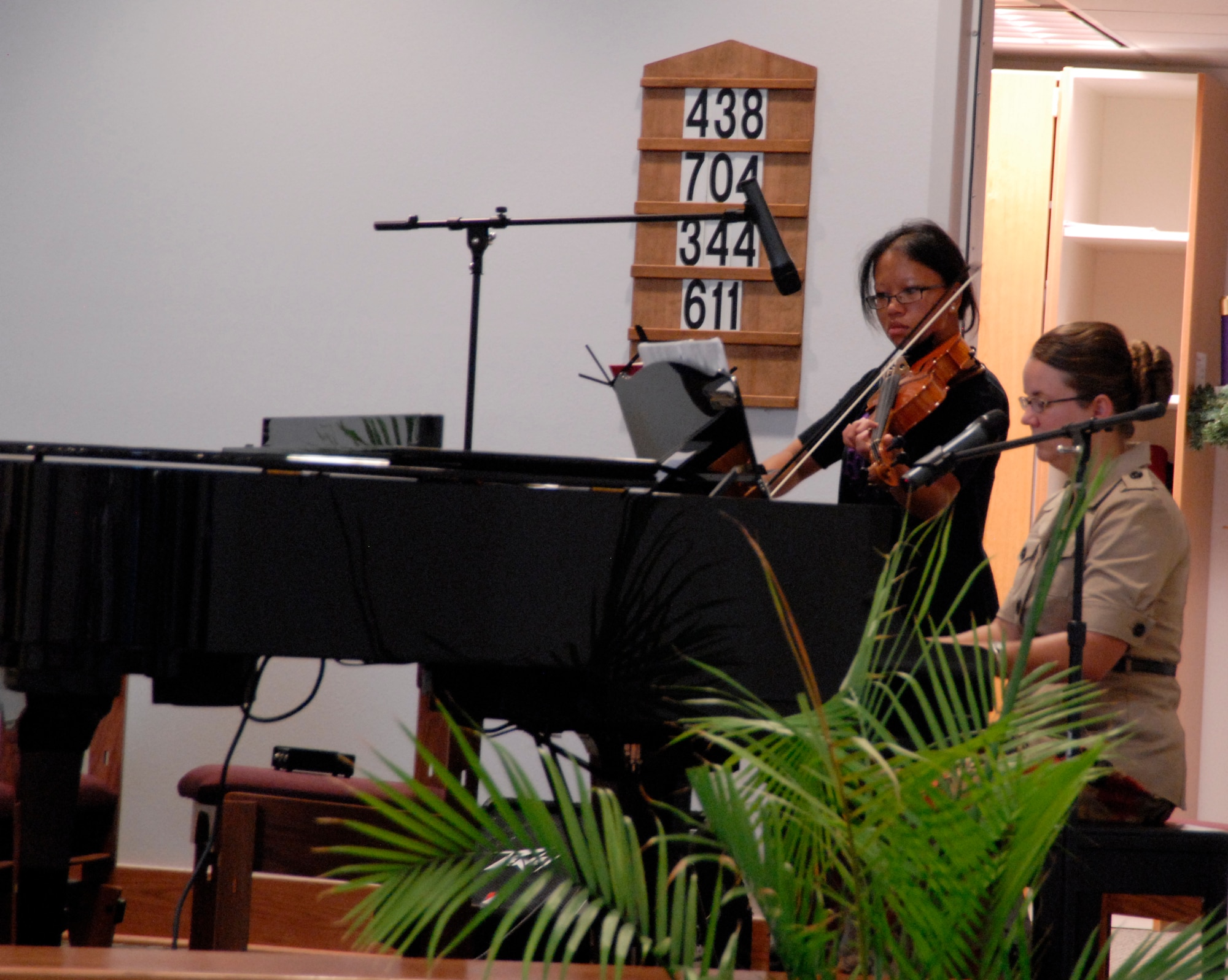 Mrs. Bonnie Averett, wife of Chaplain (Capt.) Kip Averett plays the piano while Staff Sgt. Thipthida Phommachanh, a 315th Training Squadron student plays the violin Sept. 12 during the Protestant Worship Service. (U.S. Air Force photo/Airman 1st Class Anne Gathua) 

 

