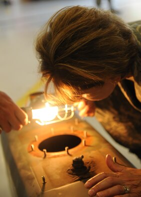MOODY AIR FORCE BASE, Ga. -- Maj. Gen. Judith Fedder, Air Combat Command director of logistics, observes the damage inside a fuel tank from a biodiesel-powered vehicle at the 23rd Logistics Readiness Squadron during her visit to Moody Air Force Base, Ga., Sept. 9. General Fedder came to Moody to recognize the Airmen for their hard work and dedication. (U.S. Air Force photo/Airman 1st Class Benjamin Wiseman) 
