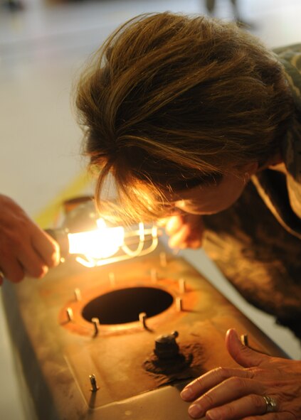 MOODY AIR FORCE BASE, Ga. -- Maj. Gen. Judith Fedder, Air Combat Command director of logistics, observes the damage inside a fuel tank from a biodiesel-powered vehicle at the 23rd Logistics Readiness Squadron during her visit to Moody Air Force Base, Ga., Sept. 9. General Fedder came to Moody to recognize the Airmen for their hard work and dedication. (U.S. Air Force photo/Airman 1st Class Benjamin Wiseman) 
