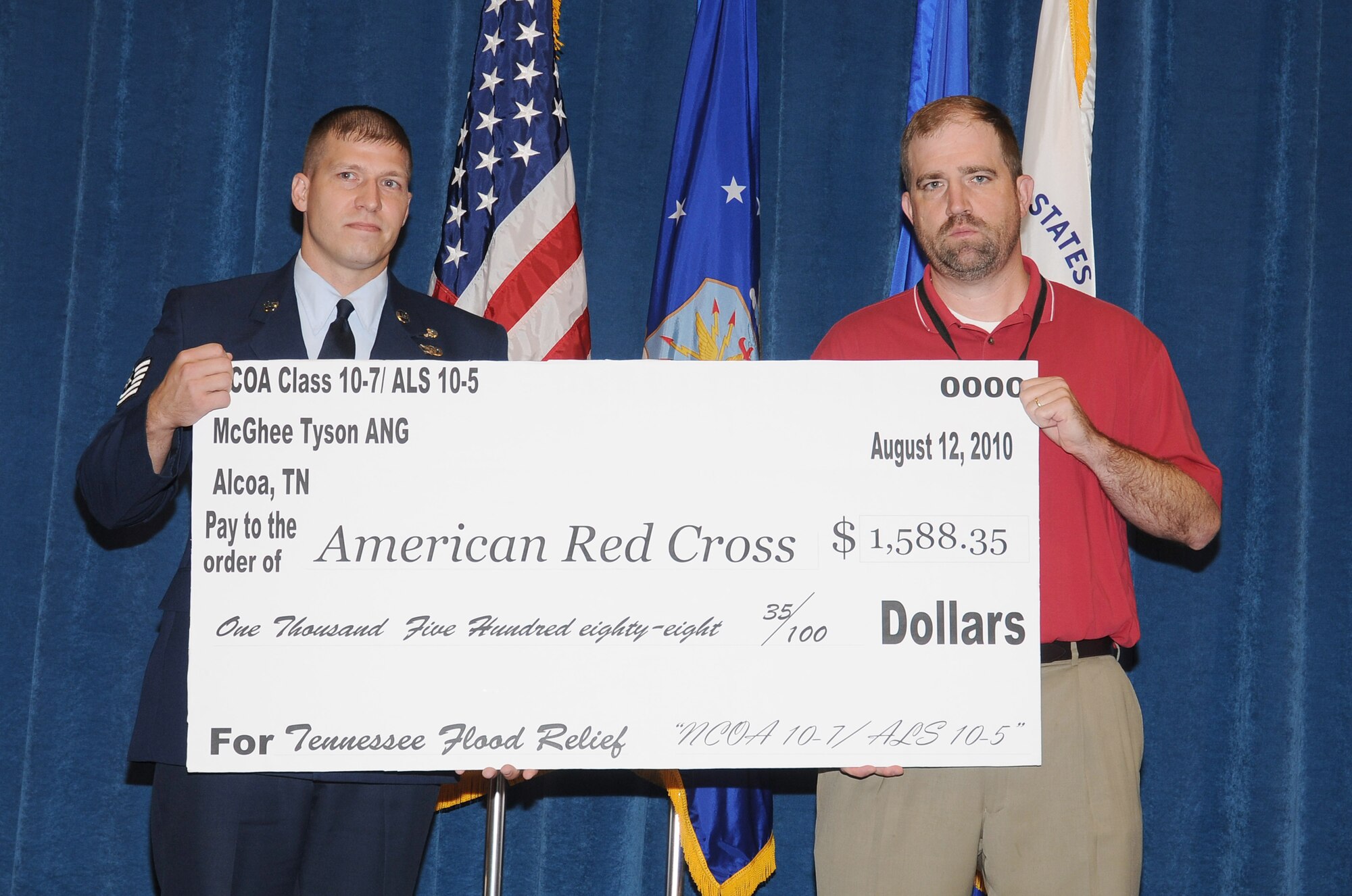 McGHEE TYSON AIR NATIONAL GUARD BASE, Tenn. - NCO Academy student, Tech. Sgt. Shane A. Merillat, left, a paralegal at Wright-Patterson AFB, Ohio, presents a check for $1,588.35 to Chris Davis, executive director for the American Red Cross, Blount County Chapter, during the combined graduation ceremony of NCO Academy Class 10-7 and Airman Leadership School Class 10-5 on the campus of The I.G. Brown Air National Guard Training and Education Center here, Aug. 12, 2010. (U.S. Air Force photo by Master Sgt. Kurt Skoglund/Released)