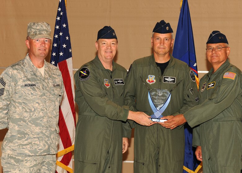 U.S. Air Force Lt. Col. Dan Tester, Wing Safety Officer, receives the Maj. Gen. John J. Pesch Flight Safety Trophy on behalf of the 174th Fighter Wing (FW) from Maj. Gen.l James Kwiatkowski, Commander of the New York Air National Guard, Col. Kevin Bradley, Commander of the 174th FW and Chief Master Sgt. David Heckman, 174th FW Command Chief at Hancock Field in Syracuse NY on 12 Sept 2010. The trophy is presented annually to two Air National Guard flying units judged to have demonstrated the highest standards of flight safety. (Photo by SSgt Ricky Best)