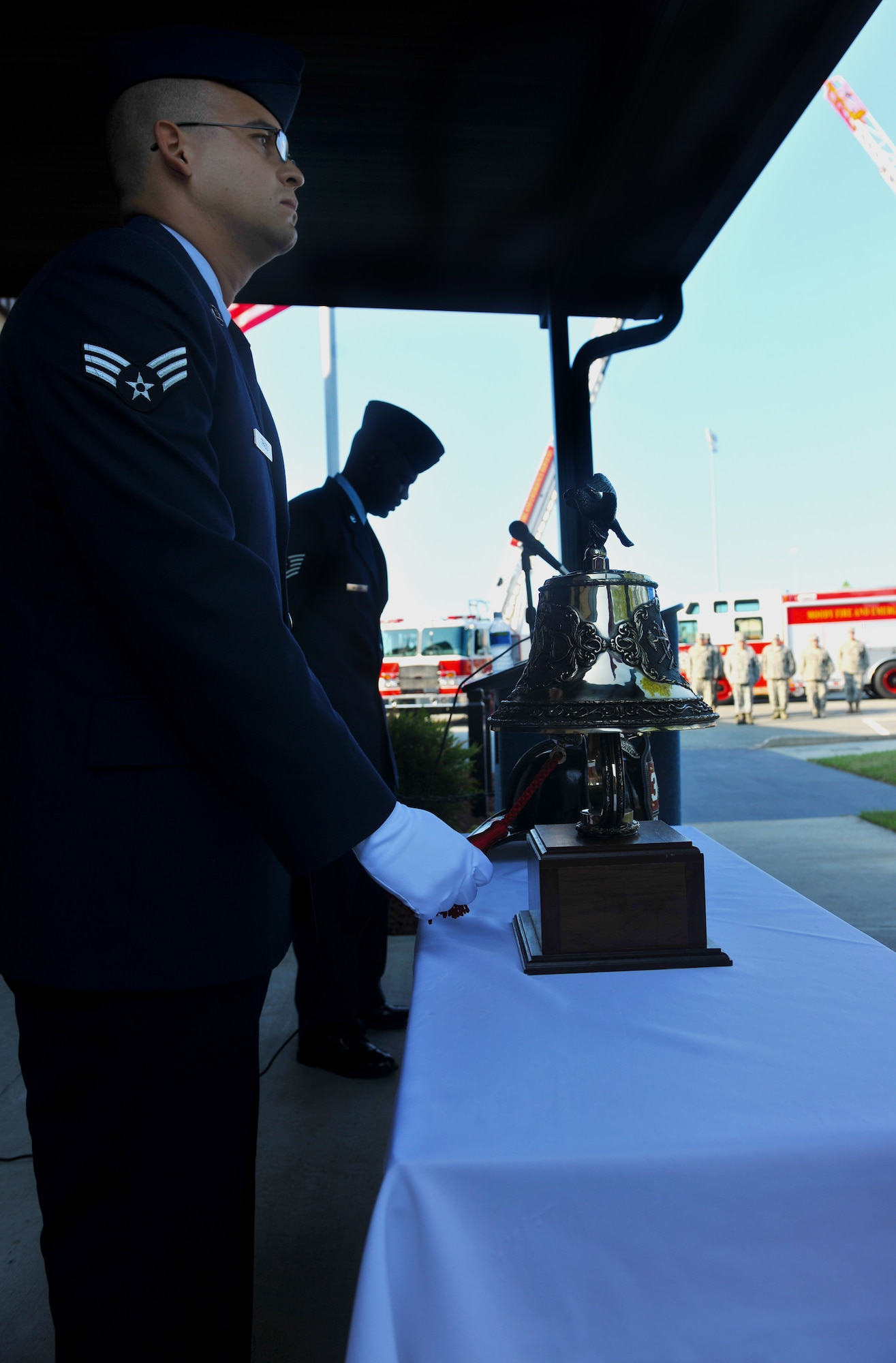 MOODY AIR FORCE BASE, Ga. -- Senior Airman Carlos Tirado, 23rd Civil Engineer Squadron firefighter, rings a fire bell symbolizing the last call for fallen firefighters during a 9/11 ceremony here Sept. 11. Moody members joined together to remember their fellow firefighters who lost their lives during the events of Sept. 11, 2001. (U.S. Air Force photo/Airman 1st Class Joshua Green)
