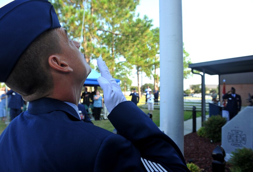 MOODY AIR FORCE BASE, Ga. -- Tech. Sgt. Alan Justice, 23rd Civil Engineer Squadron NCO logistics in-charge, looks to a flag being hoisted to half-staff during a 9/11 ceremony here Sept. 11. The ceremony took place at Moody’s Fire Department to honor those who lost their lives on that tragic day. (U.S. Air Force photo/Airman 1st Class Joshua Green)
