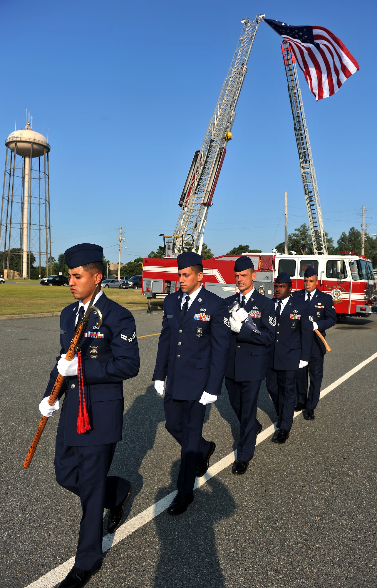 MOODY AIR FORCE BASE, Ga. -- Firefighters from the 23rd Civil Engineer Squadron practice walking along a white line before the start of a 9/11 ceremony here Sept. 11. The Airmen will present the flag at half-staff during the ceremony. (U.S. Air Force photo/Airman 1st Class Joshua Green)
