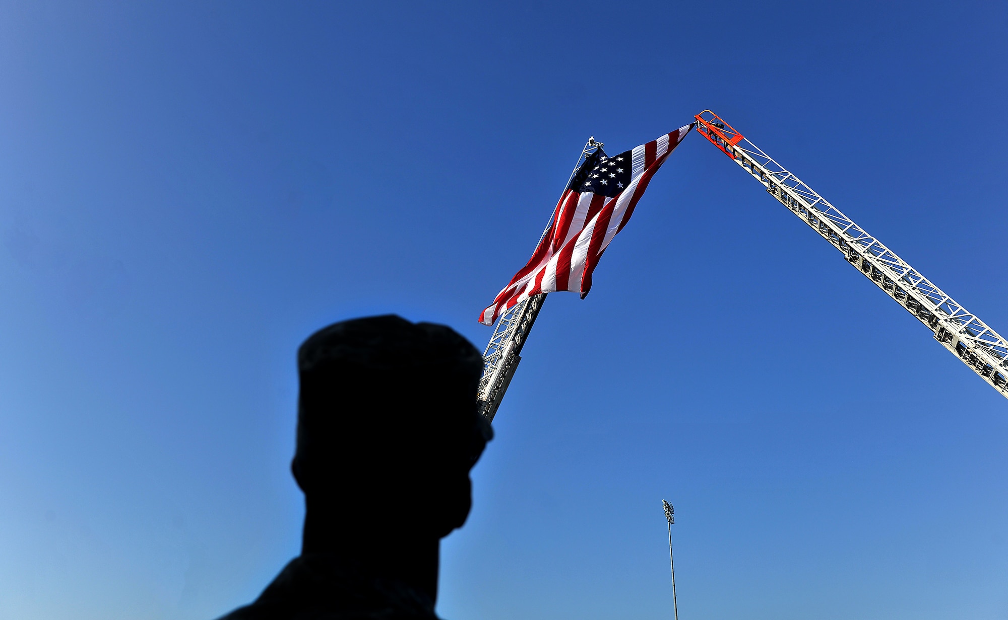 MOODY AIR FORCE BASE, Ga. -- Chief Master Sgt. Richard Parsons, 23rd Wing command chief, looks up at the American flag during a 9/11 ceremony here Sept. 11. The ceremonial event is held annually in remembrance of the tragic events that took place at the World Trade Center in New York. (U.S. Air Force photo/Airman 1st Class Joshua Green)
