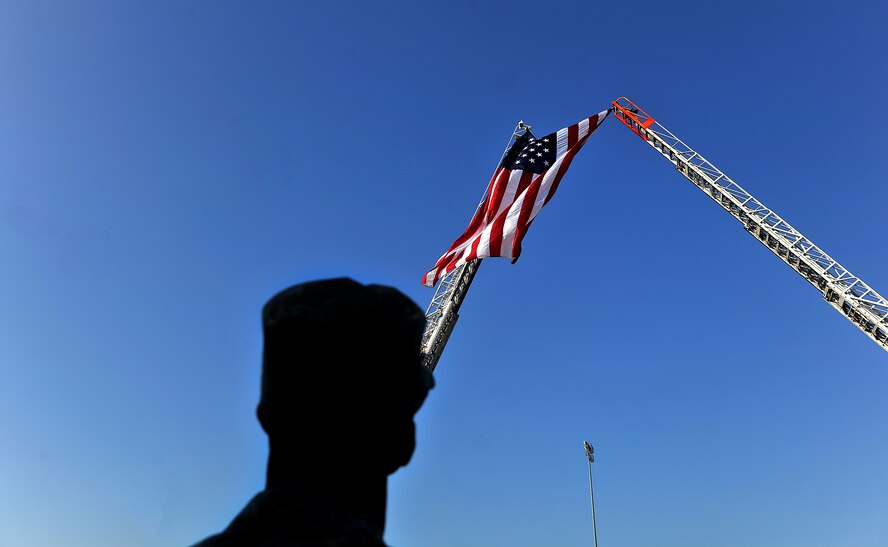 MOODY AIR FORCE BASE, Ga. -- Chief Master Sgt. Richard Parsons, 23rd Wing command chief, looks up at the American flag during a 9/11 ceremony here Sept. 11. The ceremonial event is held annually in remembrance of the tragic events that took place at the World Trade Center in New York. (U.S. Air Force photo/Airman 1st Class Joshua Green)
