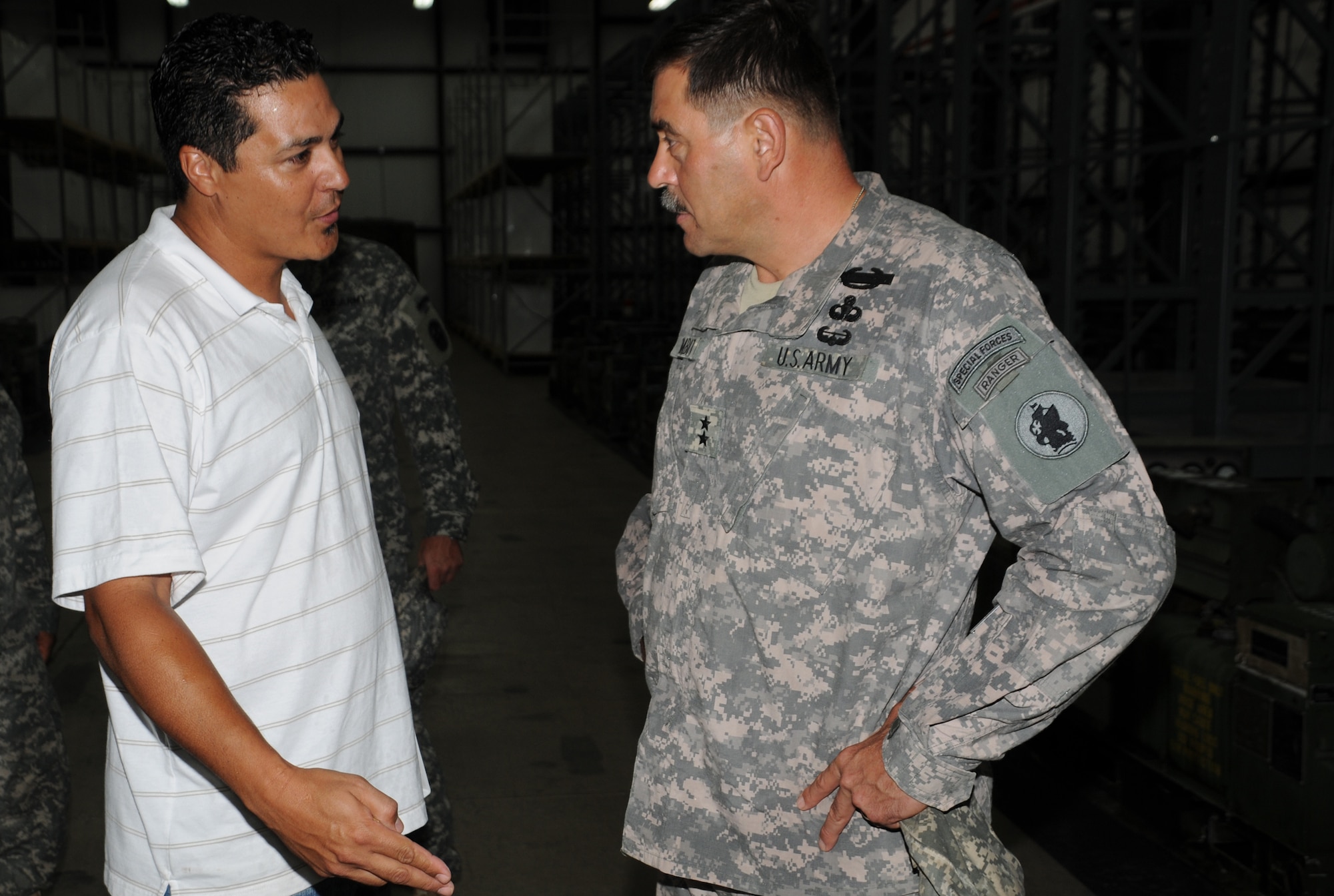 SOTO CANO AIR BASE, Honduras --  Mr. Victor Vega, the U.S. Army South equipment manager, receives a coin from Maj. Gen. Simeon Trombitas, the USARSO commanding general, here Sept. 11. Since taking command of USARSO in November, General Trombitas has visited USARSO bases to see their missions first hand. (U.S. Air Force photo/Tech. Sgt. Benjamin Rojek)