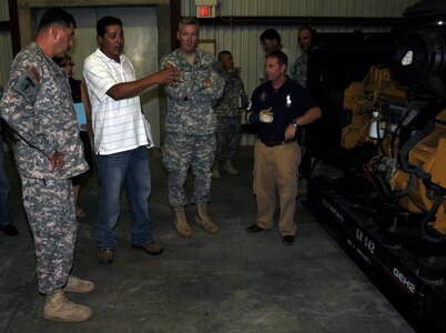 SOTO CANO AIR BASE, Honduras --  Maj. Gen. Simeon Trombitas, the U.S. Army South commanding general, left, receives a briefing on base generators from Mr. Victor Vega, the USARSO equipment manager, along with Col. Gregory Reilly, the Joint Task Force-Bravo commander, and Mr. Brian Morris, of U.S. Army South, here Sept. 11. Among other JTF-Bravo units, General Trombitas also visited the 1-228th Aviation Regiment and Army Support Activity. (U.S. Air Force photo/Tech. Sgt. Benjamin Rojek)