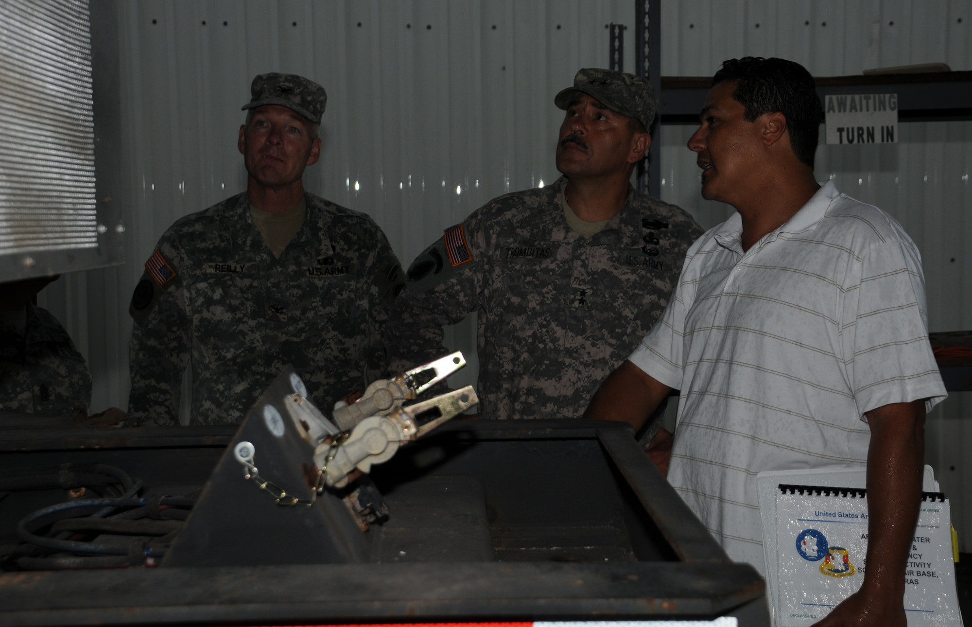 SOTO CANO AIR BASE, Honduras --  Col. Gregory Reilly, the Joint Task Force-Bravo commander, left, and Maj. Gen. Simeon Trombitas, the U.S. Army South commanding general, receive a briefing about a trailer system from Mr. Victor Vega, the USARSO equipment manager, here Sept. 11. General Trombitas, who took command of USARSO on Nov. 9, 2009, visited the base to learn more about the JTF-Bravo mission. (U.S. Air Force photo/Tech. Sgt. Benjamin Rojek)