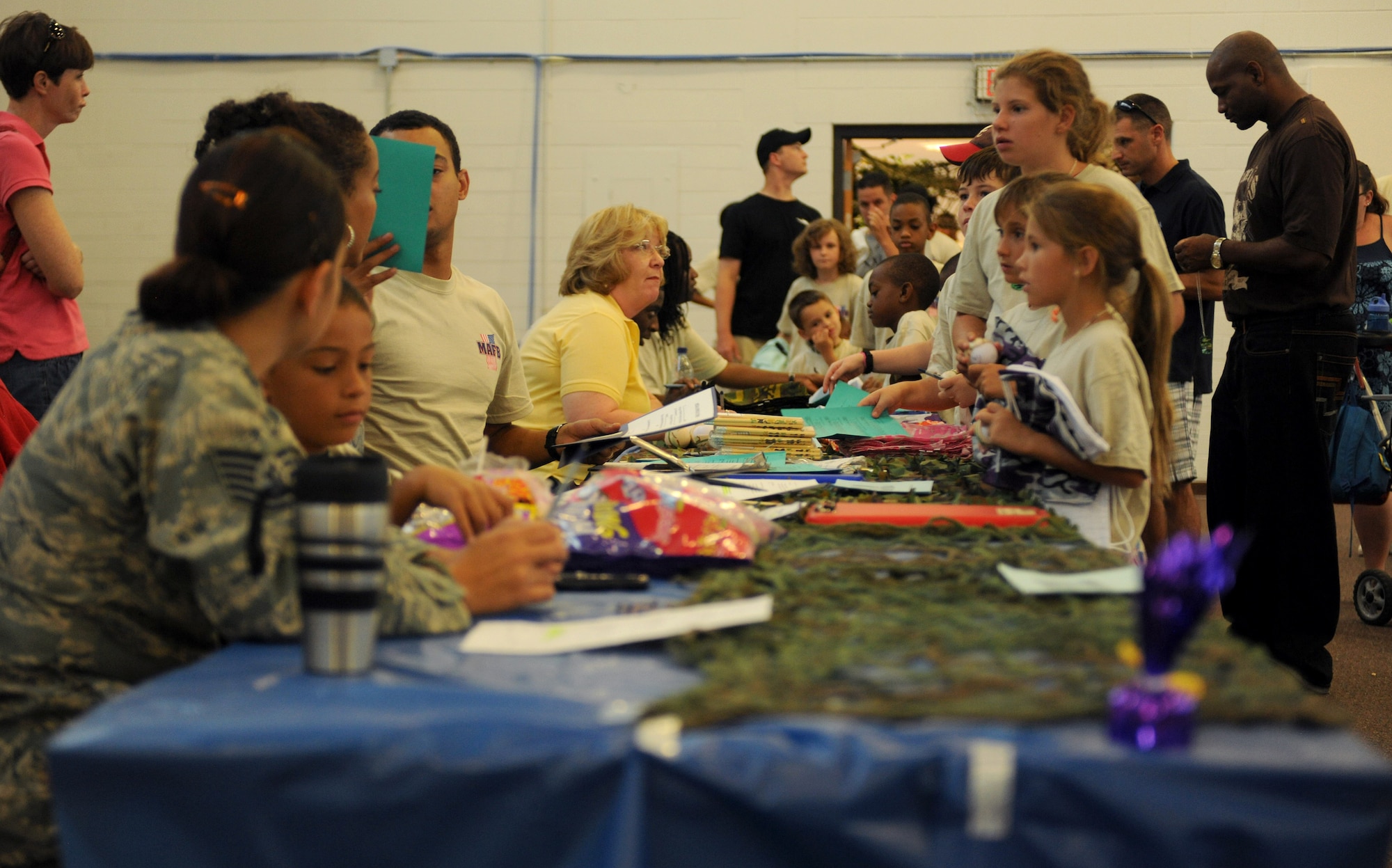 MOODY AIR FORCE BASE, Ga. -- Children attending the Kids Deployment Line start their day by processing through the deployment line here Sept. 11. Children rotated through four different stations consisting of the processing line, military working dog demonstrations, pre-deployment briefings and the display tables with the 820th Security Forces Group and 38th Rescue Squadron. (U.S. Air Force photo/Airman 1st Class Benjamin Wiseman)

