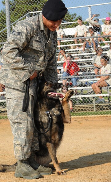MOODY AIR FORCE BASE, Ga. -- Senior Airman Steve Fuentes, 23rd Security Forces Squadron military working dog handler, gives commands to Liza, MWD, during an obedience demonstration during Kids Deployment Line here Sept. 11. The 23rd SFS showcased several teams of canines and their handlers throughout the day. (U.S. Air Force photo/Airman 1st Class Benjamin Wiseman)
