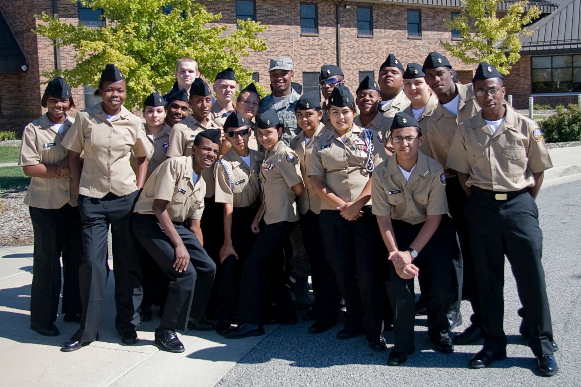 GRISSOM AIR RESERVE BASE, Ind. -- Senior Airman Bernard Johnson poses for a photo with cadets from Proviso East High School?s Naval Junior Reserve Officers Training program Sept. 8. Airman Johnson, a graduate of Indianapolis' Pike High School and a NJROTC program there, met with one of his former instructors, Miss Diane Johnson, while she toured the base with the cadets from Proviso East. The mission of the NJROTC program is to instill in students in United States secondary educational institutions the values of citizenship, service to the United States, personal responsibility and a sense of accomplishment. Airman Johnson is a knowledge operations specialist with the 434th Aircraft Maintenance Squadron. (U.S. Air Force photo/Tech. Sgt. Mark R. W. Orders-Woempner) 
