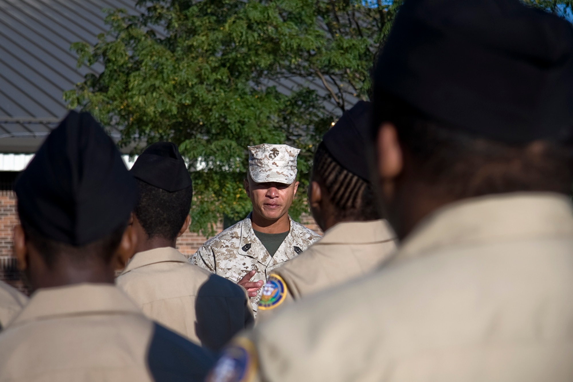 GRISSOM AIR RESERVE BASE, Ind. -- U.S. Marine Corps 1st Sgt. Ronnie Williams talks about why he is proud to serve his country during welcoming statements made to a group of Navy Junior Reserve Officers Training Corps cadets to the Marine Corps Reserve detachment here Sept. 8. The cadets visited Grissom as part of a tour where they were able to talk with Marines from Detachment 1, Communications Company, Headquarters and Service Battalion, 4th Marine Logistics Group. They also were able to climb onboard one of Grissom's KC-135R Stratotanker aircraft and talk with maintenance Airmen. (U.S. Air Force photo/Tech. Sgt. Mark R. W. Orders-Woempner)