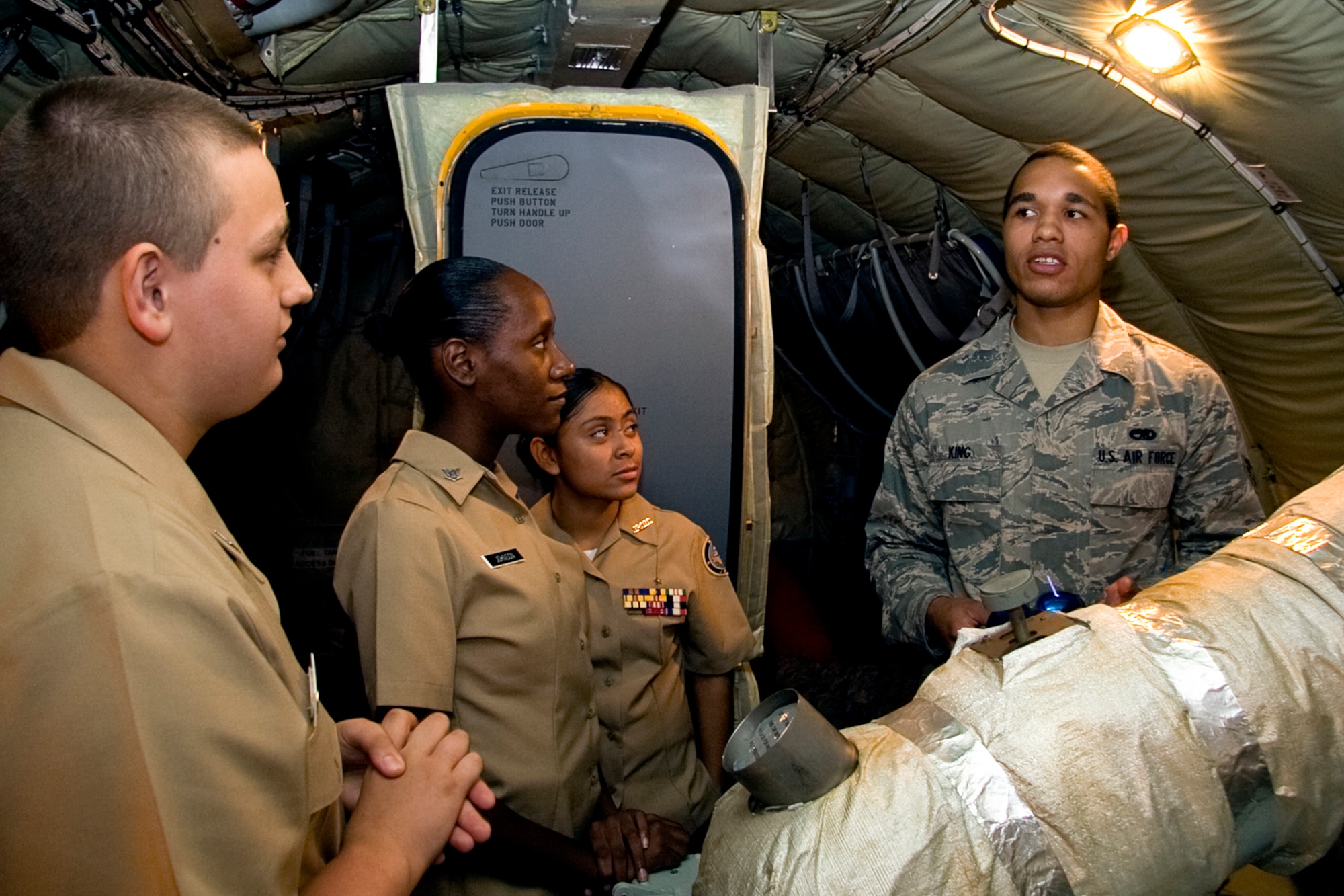 GRISSOM AIR RESERVE BASE, Ind. -- Senior Airman Cory King, an aircraft electrical and environmental specialist with the 434th Aircraft Maintenance Squadron, explains how an auxiliary power unit works to a group of Navy Junior Reserve Officers Training Corps cadets onboard a KC-135R Stratotanker here Sept. 8. The cadets visited the base to gain a better understanding of military operations and life. The group was from Proviso East High School in Maywood, Ill. An APU provides electrical power and is an air source for starting the engines during start-up procedures. (U.S. Air Force photo/Tech. Sgt. Mark R. W. Orders-Woempner)