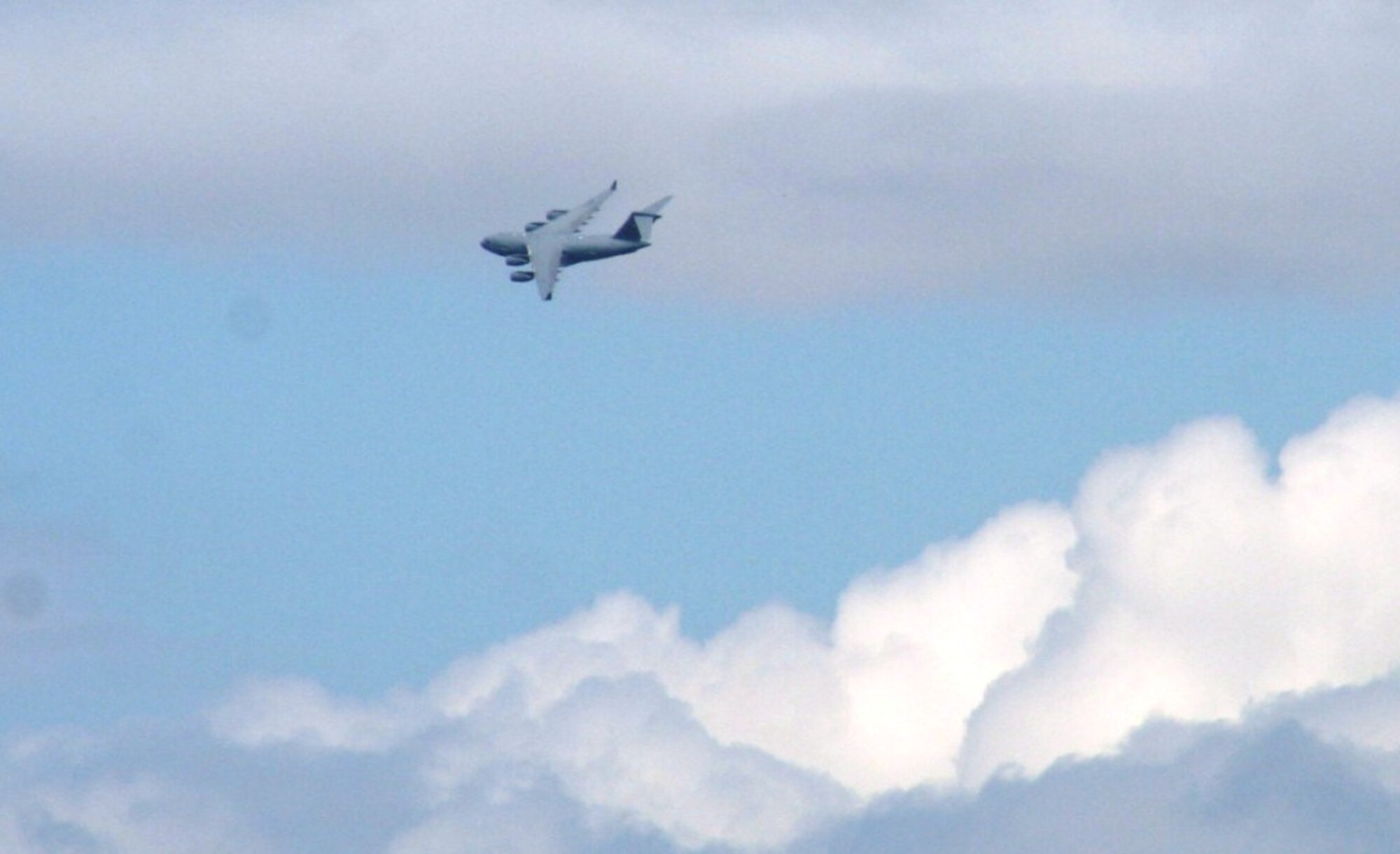 A C-17 Globemaster III crew from the 97th Air Mobility Wing at Altus Air Force Base, Okla., flies a C-17 over Scott AFB, Ill., on Sept. 11, 2010. The C-17 and the Airmen who fly and maintain it were on hand to hold an aerial demonstration for the 2010 Airpower Over The Midwest Airshow at Scott AFB. During the two-day airshow, tens of thousands of people attended. The C-17 is the Air Force's and Air Mobility Command's newest airlift aircraft. (U.S. Air Force Photo/Master Sgt. Scott T. Sturkol)
