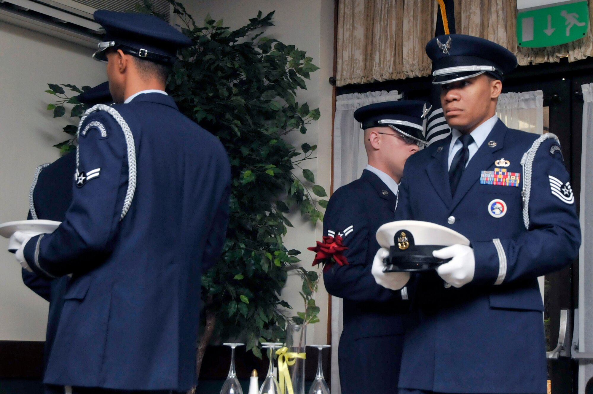 Tech. Sgt. Cory McKelvey, 48th Fighter Wing honor guard member, holds the U.S. Navy cover while setting up the POW/MIA table at Eagles’ Landing on Sept. 13 at RAF Lakenheath, England. The POW /MIA breakfast was the first event of a week-long remembrance, this includes a 24-hour vigil, a 5-k run and motorcycle rally. (U.S. Air Force photo/Airman 1st Class Eboni Knox)