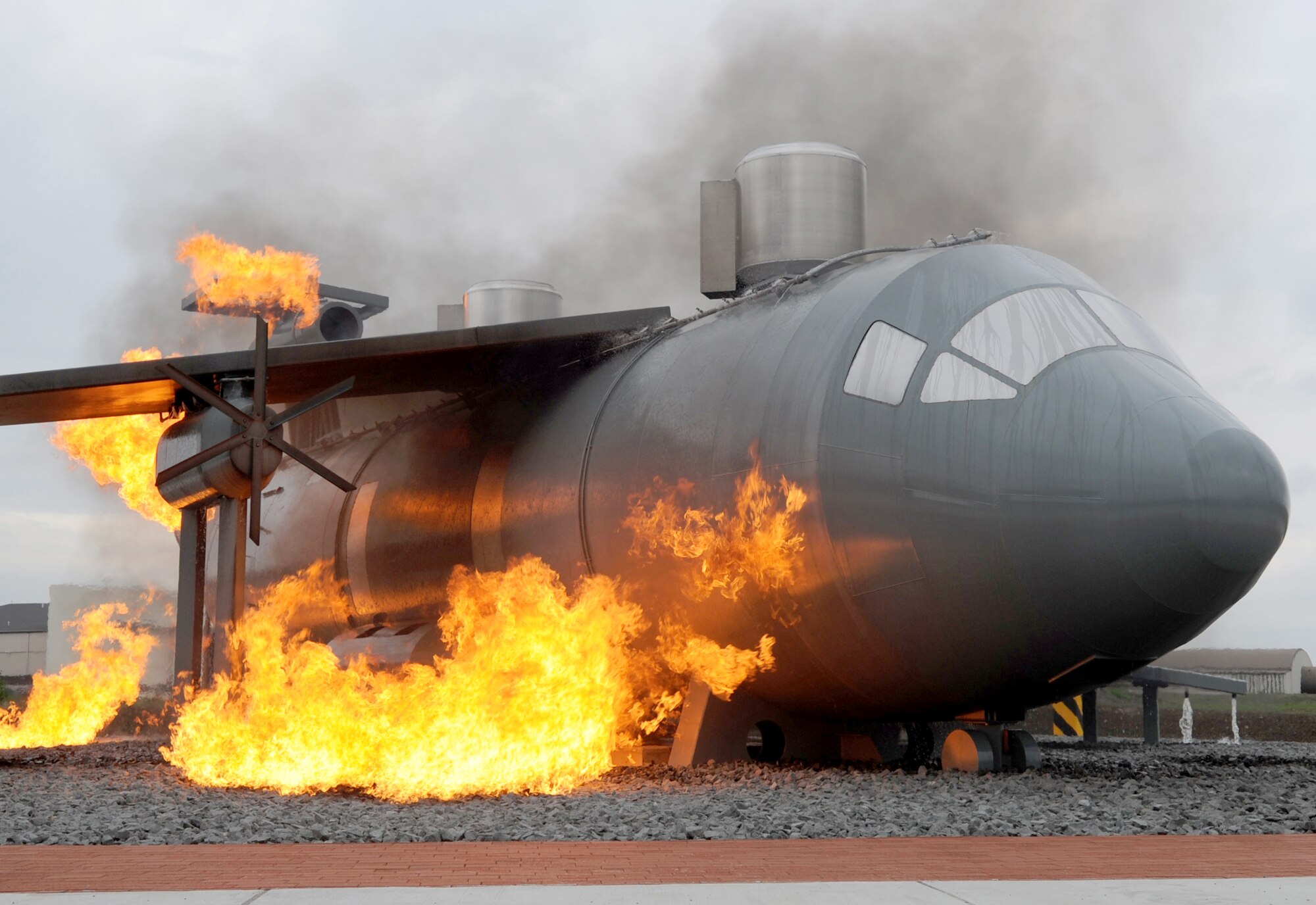 A new aircraft fire training burn site is engulfed in flames for construction team members and fire trainers to view Sept. 9, 2010 at Ramstein Air Base, Germany. The new burn site is the only aircraft training site in Germany. (U.S. Air Force photo/Senior Airman Caleb Pierce) 