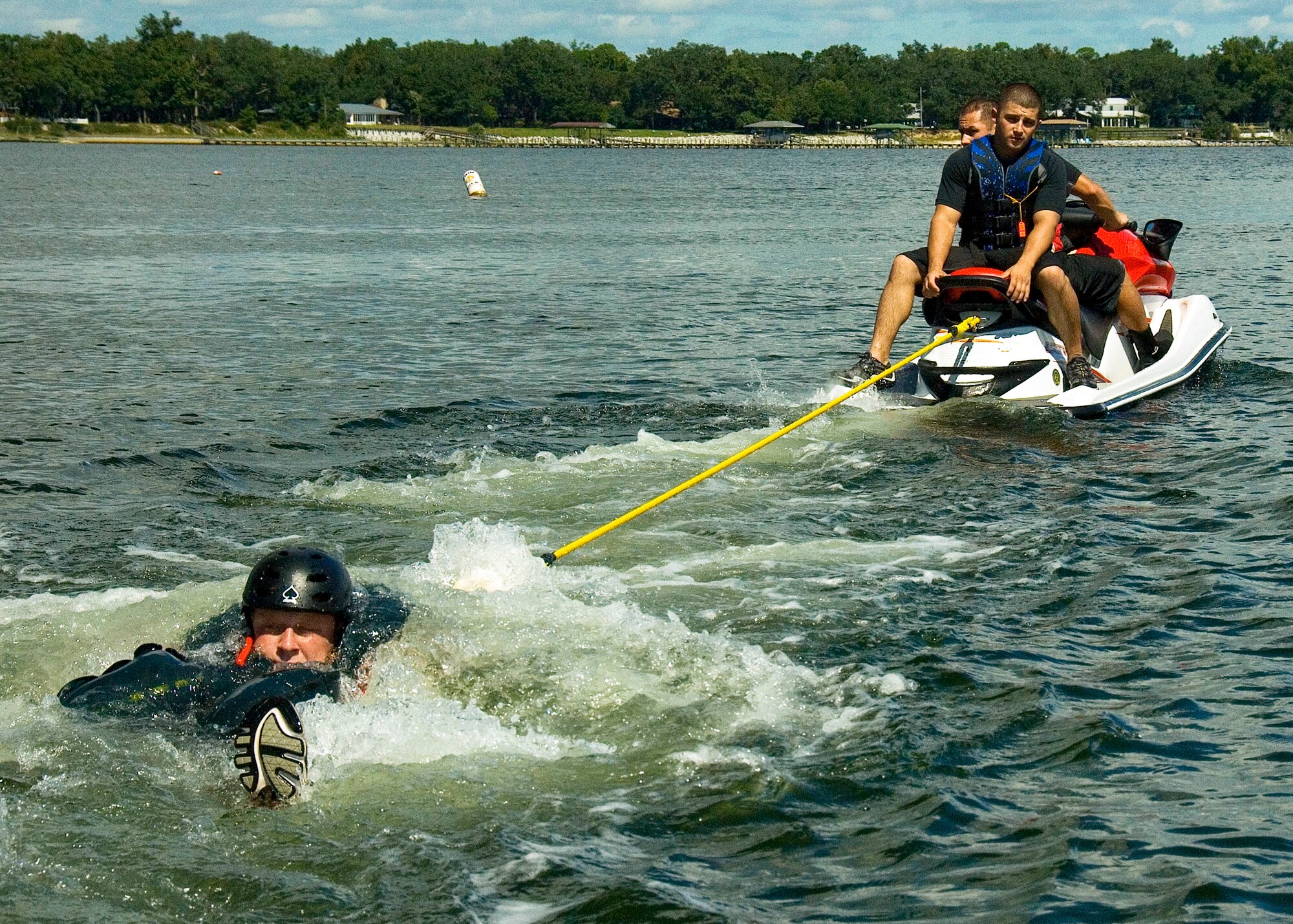 EGLIN AIR FORCE BASE, Fla. -- Aircrew flight equipment specialists pull a student behind their watercraft Sept. 10, giving practical experience on how to release a parachute harness while in the water. More than a dozen aircrew members received the water survival training that day at Post'l Point.  (U.S. Air Force photo/Staff Sgt. Felicia L. Welch) 