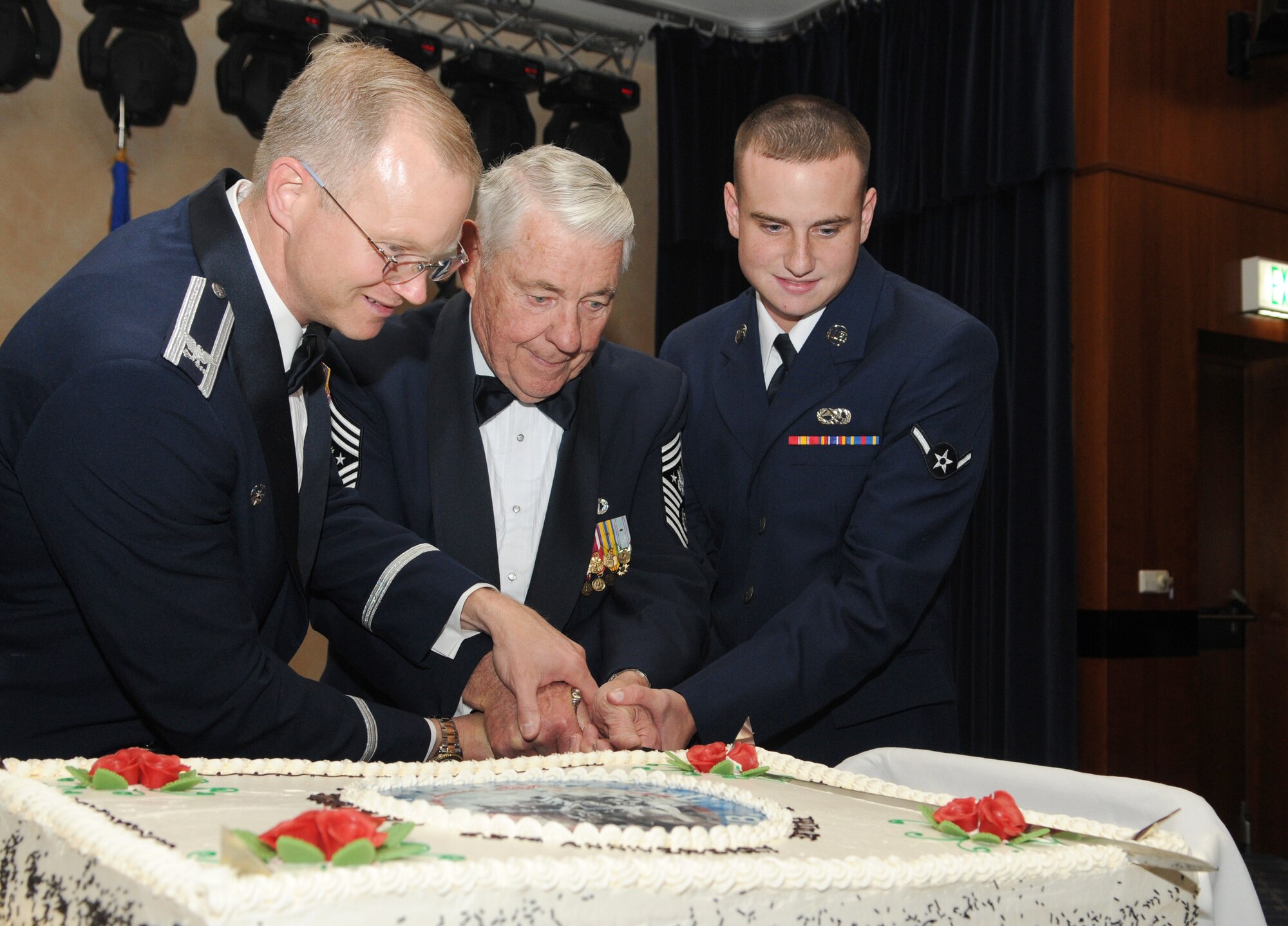 SPANGDAHLEM AIR BASE, Germany – Col. Christopher Weggeman, left, 52nd Fighter Wing commander; Robert D. Gaylor, center, fifth Chief Master Sgt. of the Air Force; and Airman Jonathan Atstupenas cut the cake using a saber during the 2010 Air Force Ball Sept. 10. The event celebrated the Air Force’s 63 years as an independent service. (U.S. Air Force photo/Staff Sgt. Benjamin Wilson)