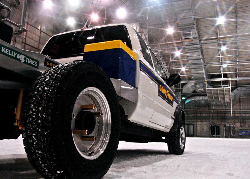 A Goodyear test vehicle waits to spin the tires on the snowy track in the McKinley Climatic Lab Sept. 9 at Eglin Air Force Base, Fla.   The company demonstrated the tire’s snow traction and ice braking capabilities to potential customers from Northern U.S. states and Canada as well as media.  (U.S. Air Force photo/Samuel King Jr.) 