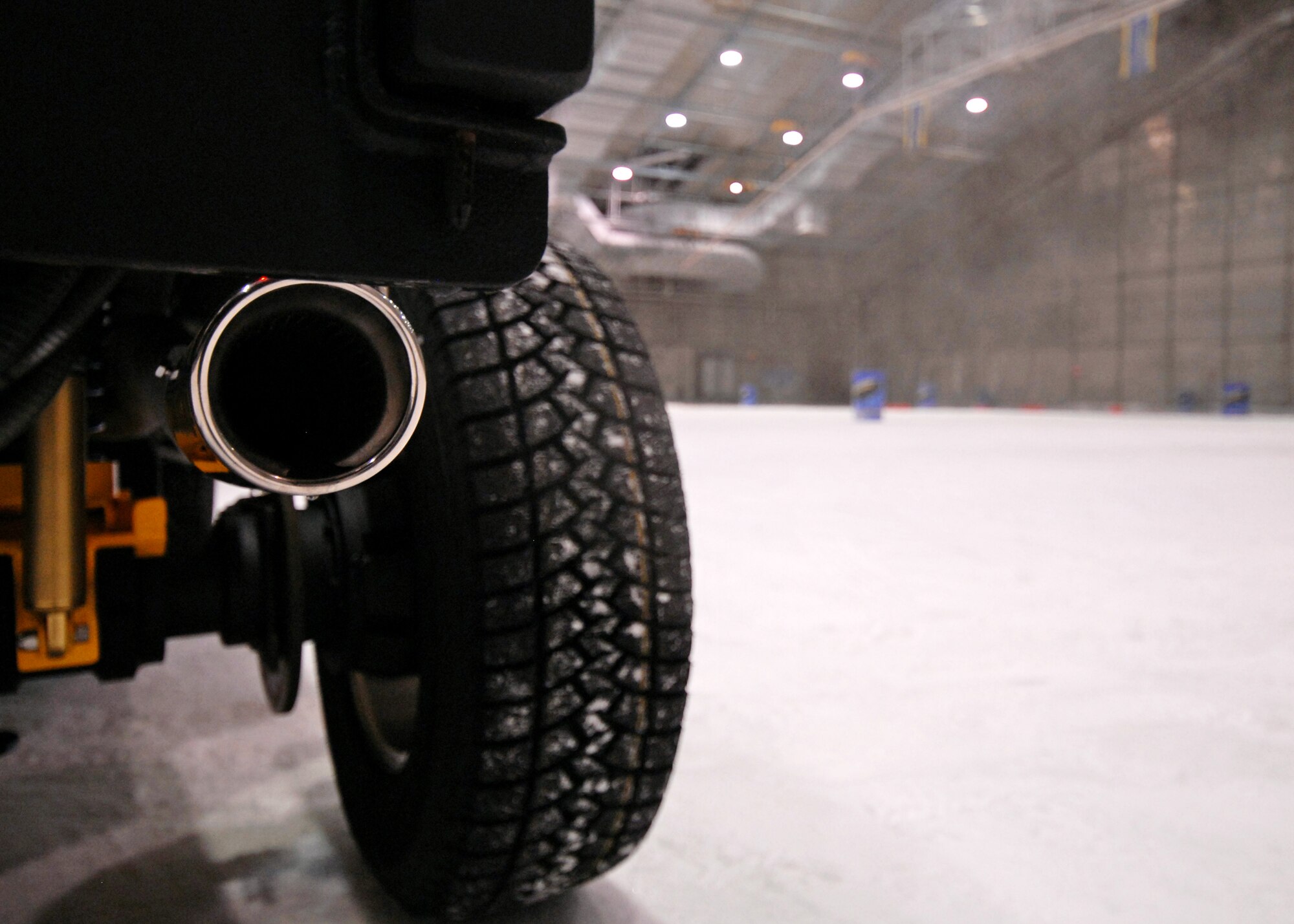 Hot exhaust wafts up from the test vehicle into the 20-degree McKinley Climatic Lab chamber during testing of a new ice tire by Goodyear, Sept. 9 at Eglin Air Force Base, Fla.  The company demonstrated the tire’s snow traction and ice braking capabilities to potential customers from Northern U.S. states and Canada as well as media.  (U.S. Air Force photo/Samuel King Jr.)