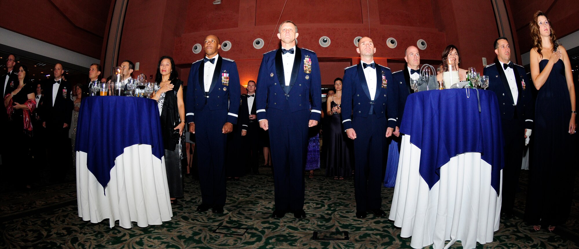 Military members and civilians alike pay respect to the United States and Italian national anthems as they are being sung at the opening of Aviano’s 63rd Air Force Ball Sept. 10 at the La Bella Vista Club.  It is tradition that the youngest and oldest Airmen cut the cake in celebration of the Air Force becoming its own military branch of service.  The event which honored the anniversary of the Air Force becoming its own branch in the U.S. military on Sept. 18, 1947,  provided a special social occasion for the Air Force community based on the theme "Celebrating Partnership: Passato e Presente." (U.S. Air Force photo/Airman 1st Class Katherine Windish)