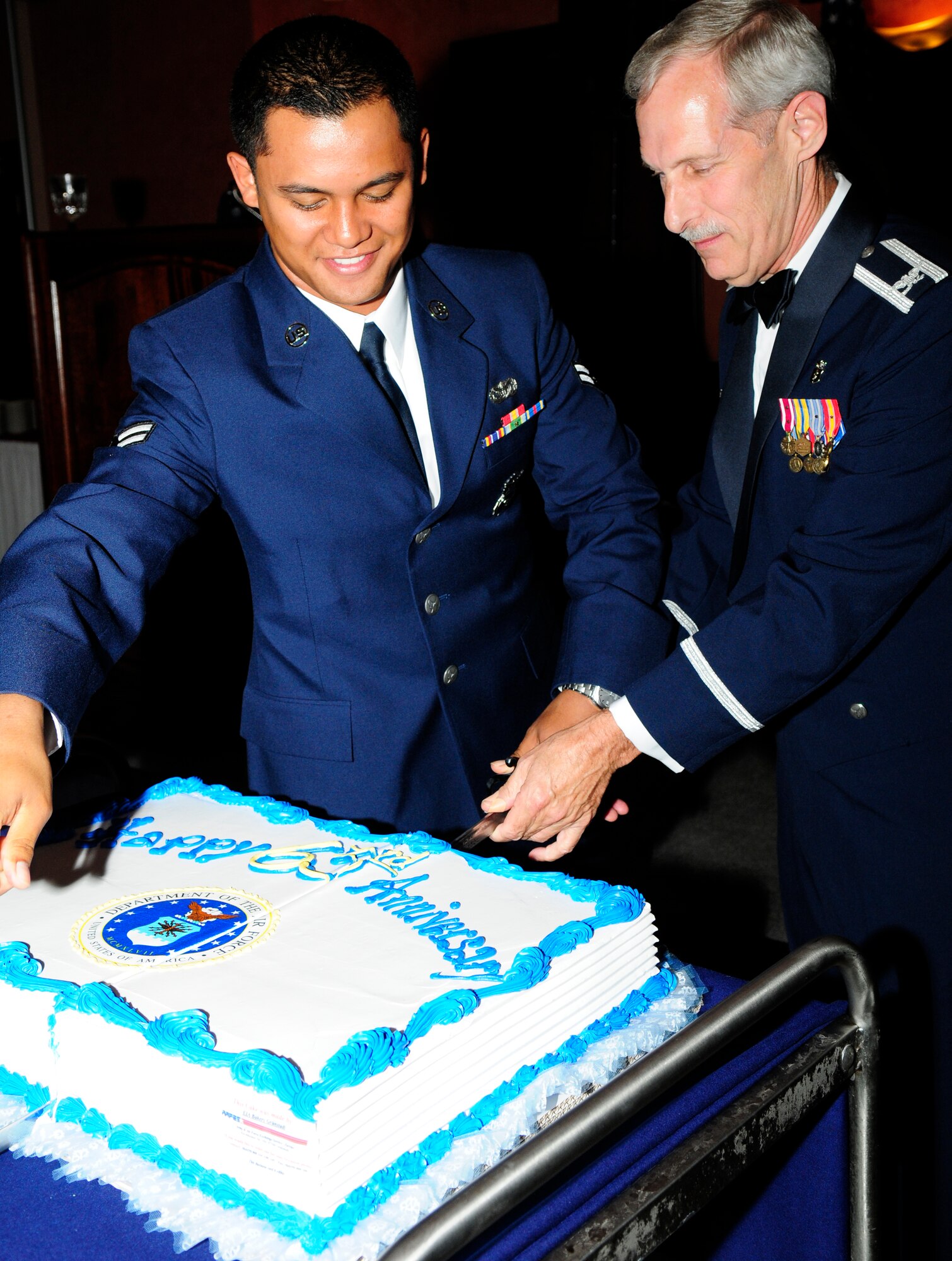 Airman 1st Class Jahmall Maave-Kuewa, 31st Security Forces Squadron, and Col. Thomas Grimm, 31st Dental Squadron commander, cut the Air Force’s Birthday cake. It is tradition that the youngest and oldest Airmen cut the cake in celebration of the Air Force becoming its own military branch of service.  The event which honored the anniversary of the Air Force becoming its own branch in the U.S. military on Sept. 18, 1947,  provided a special social occasion for the Air Force community based on the theme "Celebrating Partnership: Passato e Presente." (U.S. Air Force photo/Airman 1st Class Katherine Windish)