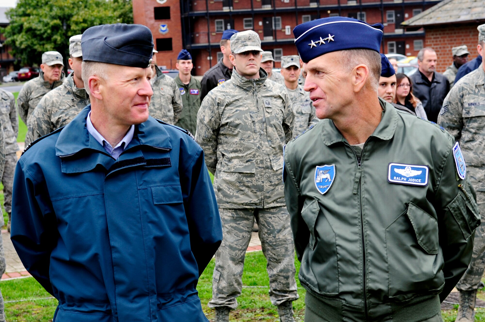 RAF MILDENHALL, England – Sqn. Ldr. Rick Fryer, RAF Mildenhall station commander, and Lt. Gen. Ralph J. Jodice II, Commander, Allied Air Component Command Headquarters and 16th Air Expeditionary Task Force, Izmir, Turkey, converse at the 9/11 Remembrance Ceremony here Sept. 10. The British and American commanders attended the ceremony, along with members of RAF Mildenhall, to remember and honor those who lost their lives in the events of Sept. 11. (U.S. Air Force photo/Senior Airman Ethan Morgan)  