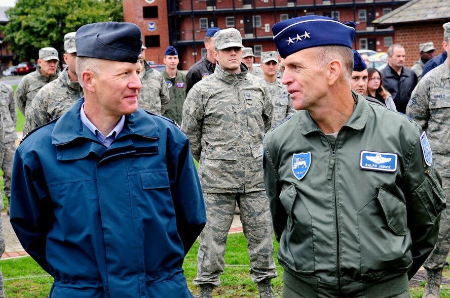 RAF MILDENHALL, England – Sqn. Ldr. Rick Fryer, RAF Mildenhall station commander, and Lt. Gen. Ralph J. Jodice II, Commander, Allied Air Component Command Headquarters and 16th Air Expeditionary Task Force, Izmir, Turkey, converse at the 9/11 Remembrance Ceremony here Sept. 10. The British and American commanders attended the ceremony, along with members of RAF Mildenhall, to remember and honor those who lost their lives in the events of Sept. 11. (U.S. Air Force photo/Senior Airman Ethan Morgan)  