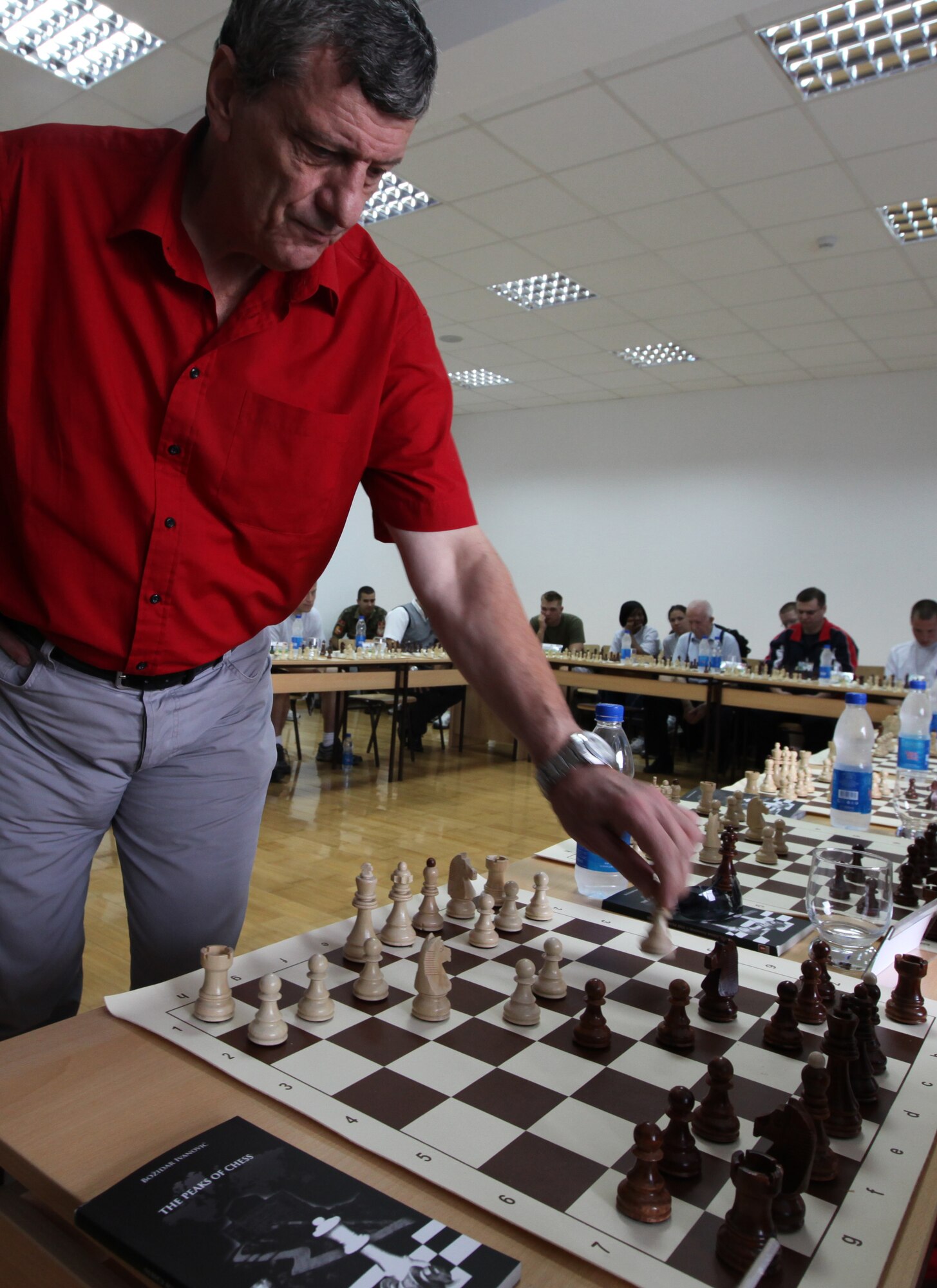 DANILOVGRAD, Montenegro – Montenegrin chess great Bozidar Ivanovic makes his move against Marine Corps Staff Sgt. Chris Mitchell, a personnel retrieval and processing specialist with Detachment PRP Smyrna, Ga., aboard the Danilovgrad Training Base in central Montenegro. The men played their game during the sports day of Medical Training Exercise in Central and Eastern Europe 2010. The exercise brings together approximately 250 servicemembers from the armed forces of the U.S. and nine central and eastern European countries for mass casualty scenario response training. For more information, visit www.usafe.af.mil/medceur.asp and www.odbrana.gov.me. (U.S. Marine photo/Lance Cpl. Jad Sleiman)
