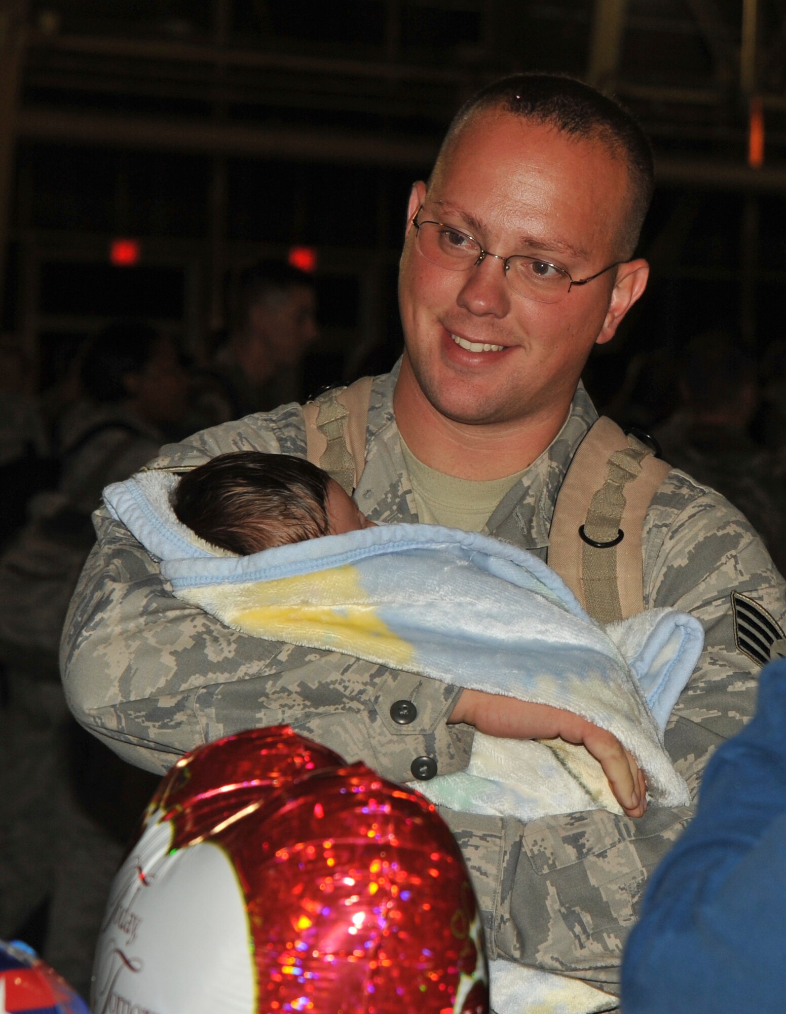 U.S. Air Force Staff Sgt.  David Wierzchowski, 35th Aircraft Maintenance Squadron, holds his 6-week old son, Alex, for the first time Sept. 13, 2010. Sergeant Wierzchowski was deployed for six months to Kunsan Air Base, Korea. (U.S. Air Force photo/Tech. Sgt. Russell McBride/Released)