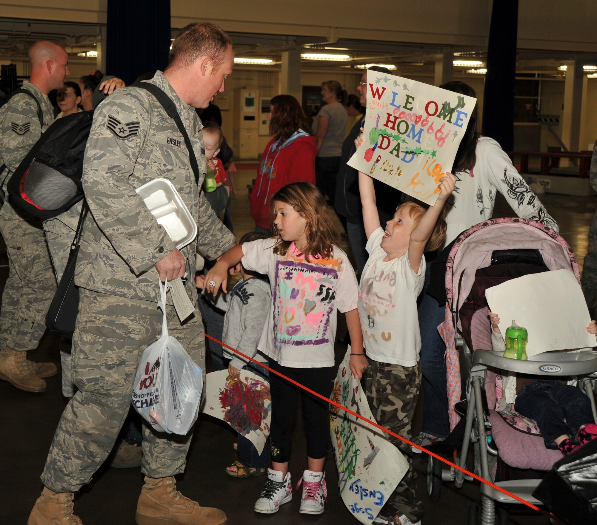U.S Air Force Staff Sgt. Robert Ensley, 35th Aircraft Maintenance Squadron, left, is welcomed home Sept. 13, 2010, by his daughter, Emily, center, and son, Justin, right. Sergeant Ensley was deployed for six months to Kunsan Air Base, Korea, (U.S. Air Force photo/Tech. Sgt. Russell McBride/Released)