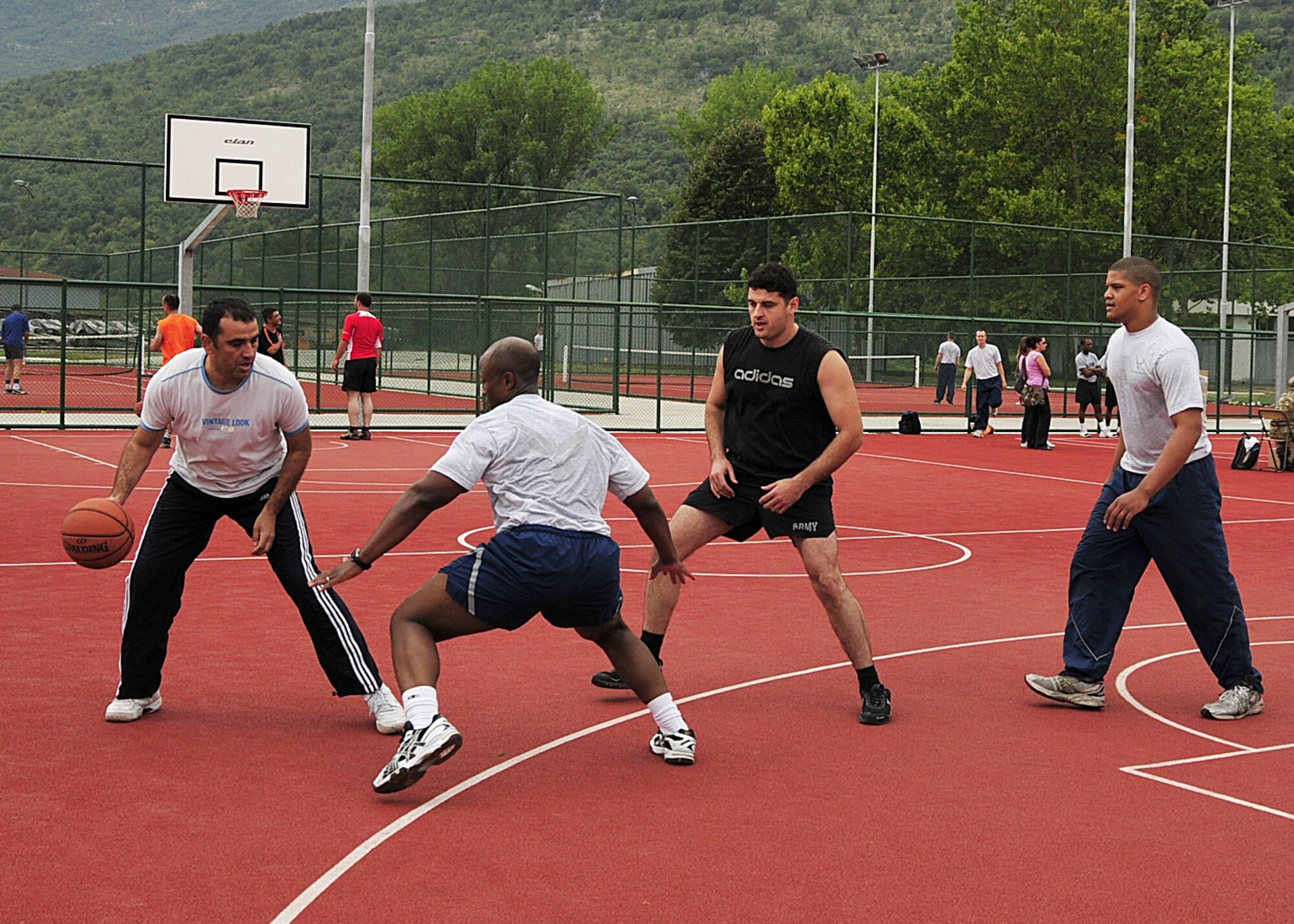 Macedonian Armed Forces Staff Sgt. Boban Angelovski dribbles ball as U.S. Air Force Maj. Ramone Toliver, an emergency physician from the 48th Medical Operations Squadron at RAF Lakenheath, England, blocks and Macedonian Armed Forces Staff Sgt. Goce Gorgievski and U.S. Air Force Airman 1st Class Jamall Haywood Van, a medical logistics journeyman from the 48th Medical Surgical Squadron at RAF Lakenheath stand ready during a basketball game at Danilovgrad Army Base, Montenegro, Sept. 12. Fitness is an intregal part of any military force and will help the armed forces during MEDCEUR10, a medical training exercise in central and eastern Europe. For more information, go to www.usafe.af.mil/medceur.asp and www.odbrana.gov.me. (U.S. Air Force photo/Airman 1st Class Tiffany Deuel)